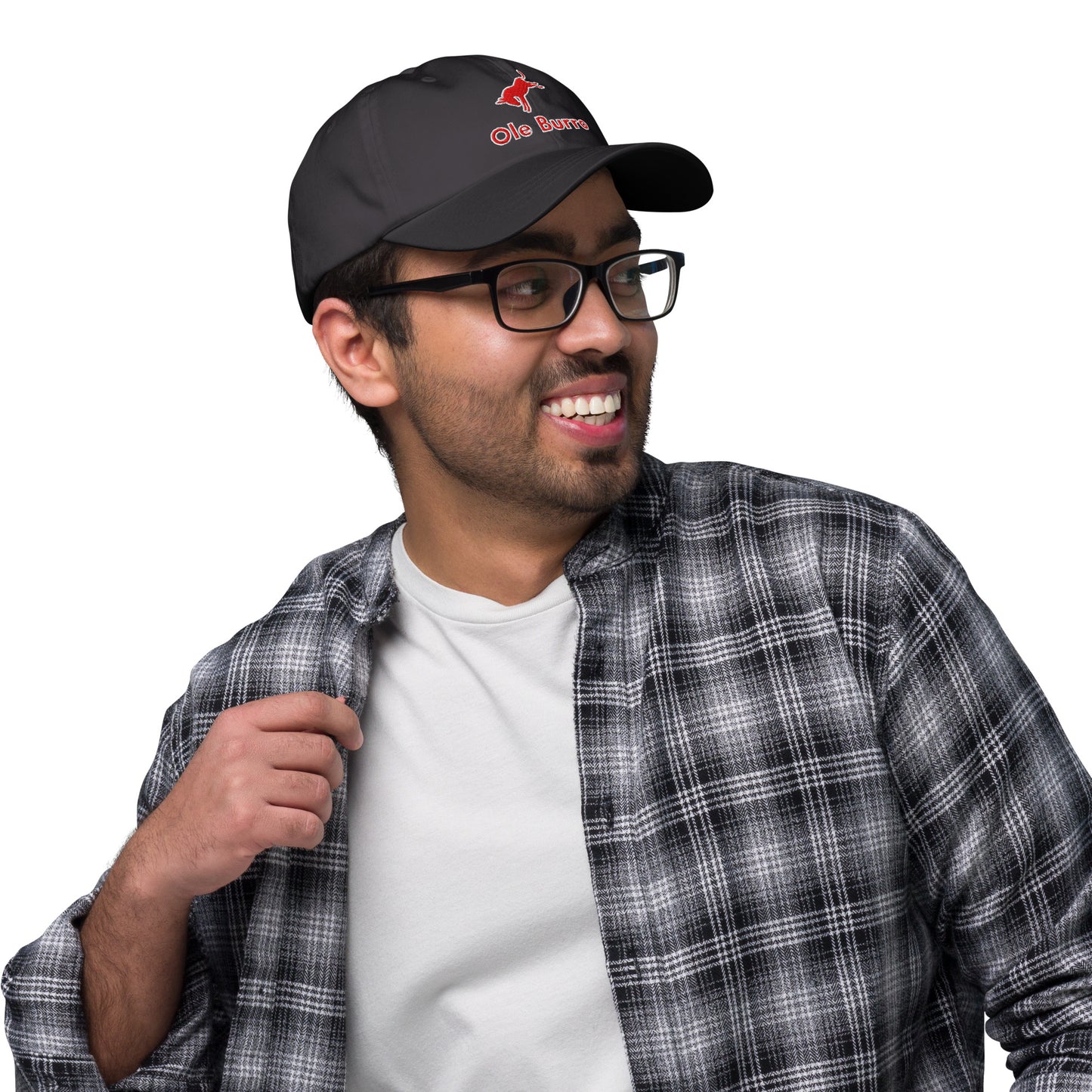 Man wearing a black cap with a logo, plaid shirt, and glasses on a white background