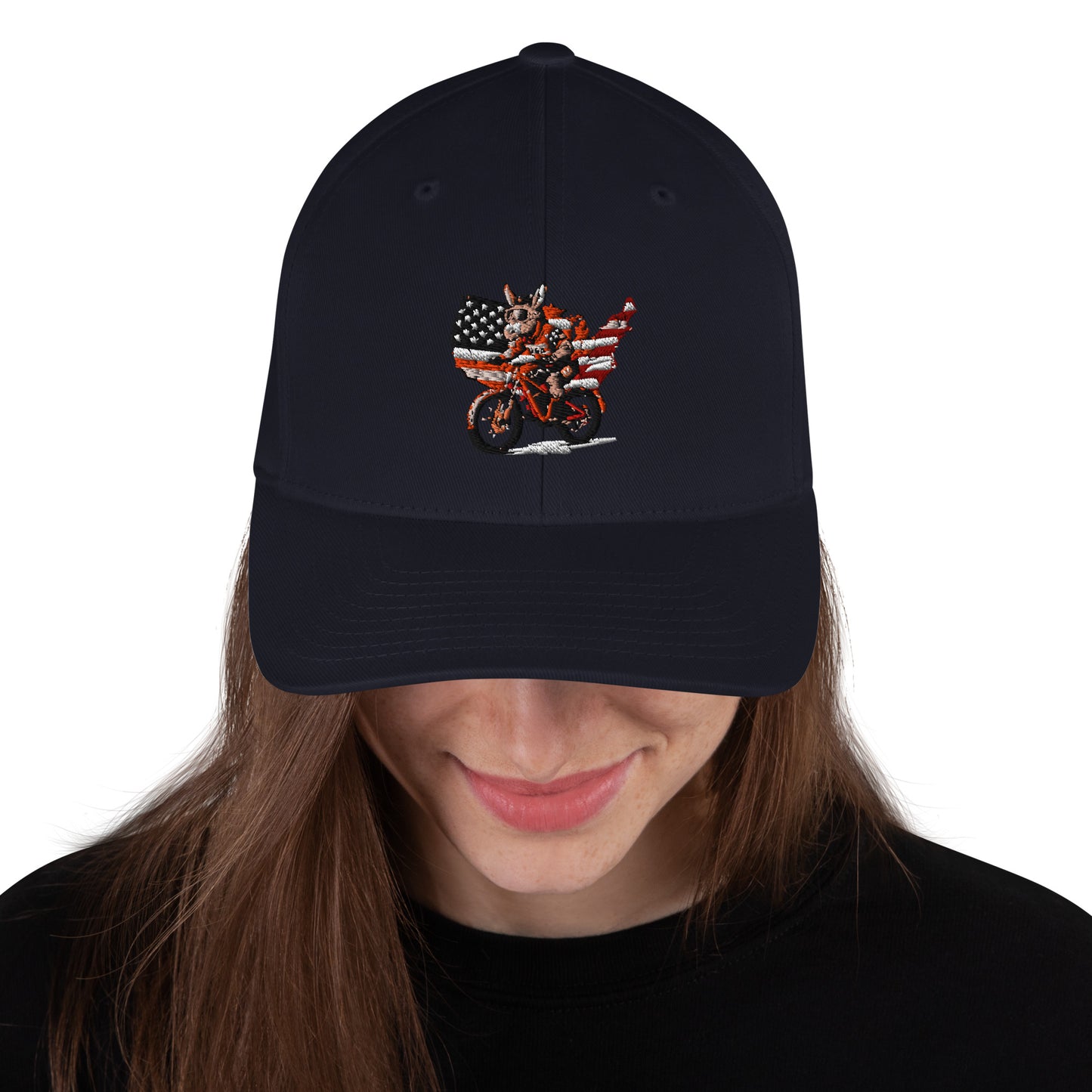 Black cap with embroidered design worn by a person on a white background