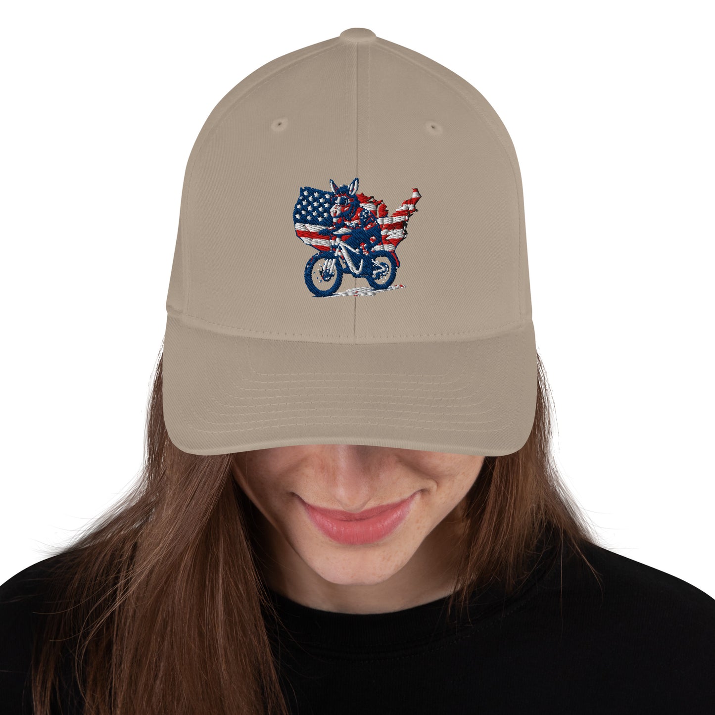 Beige cap with American flag and motorcycle design worn by a person on a white background