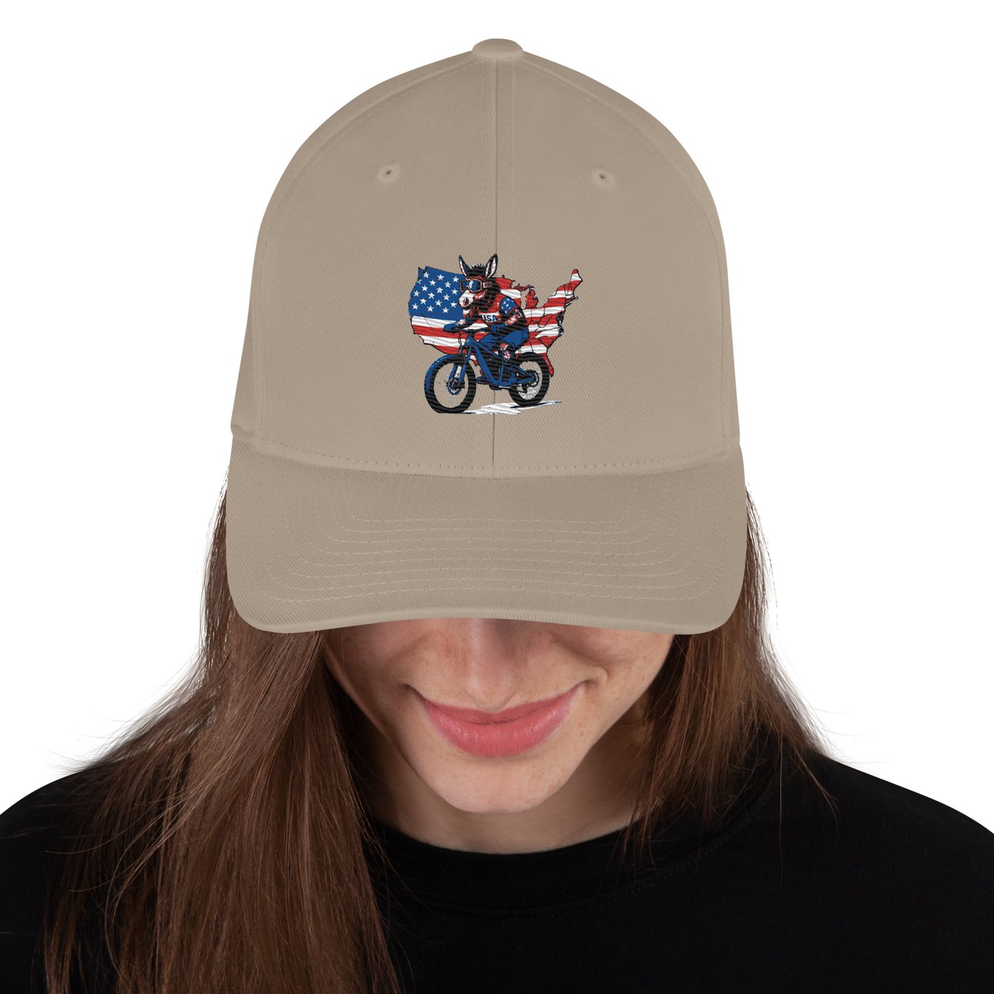 Beige cap with a graphic of a person on a motorcycle and American flag, worn by a person with long brown hair.