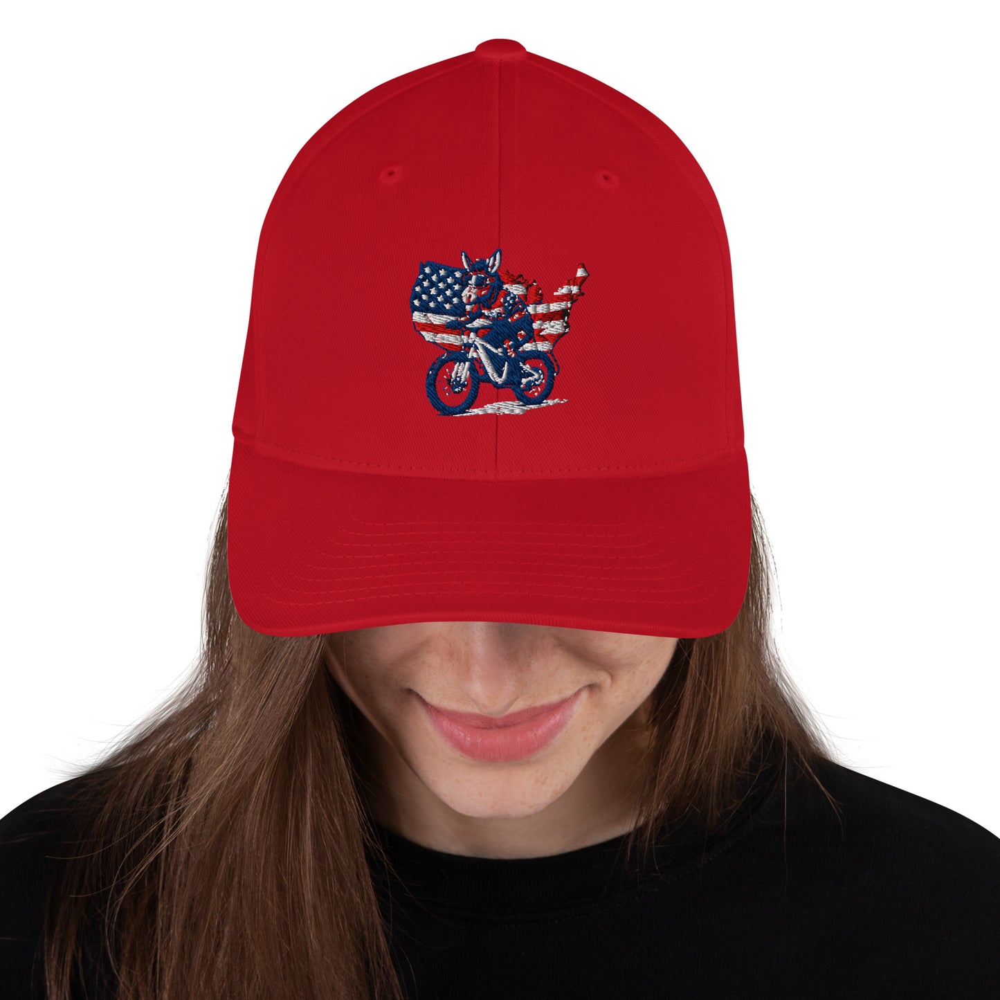 Red cap with a graphic design of an American flag and motorcycle, worn by a person.