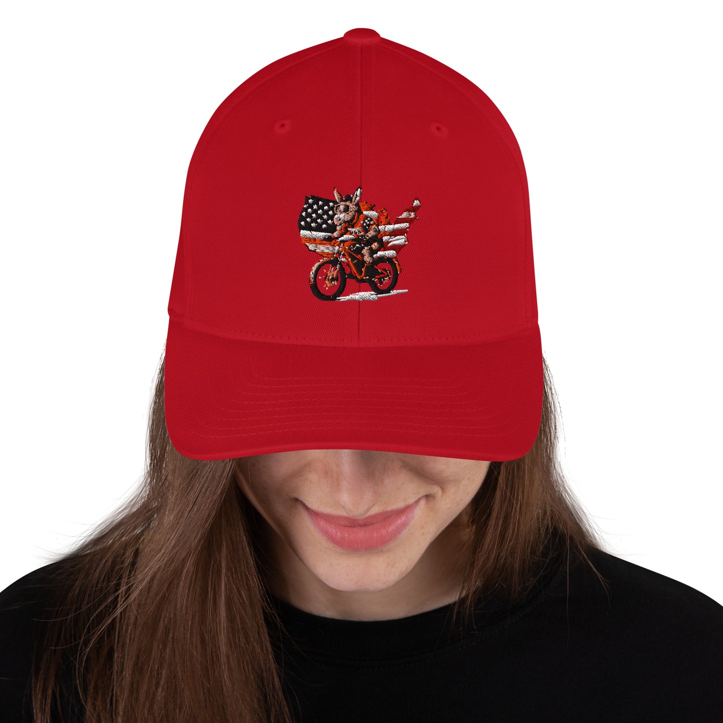 Red cap with a motorcycle and American flag design worn by a person on a white background