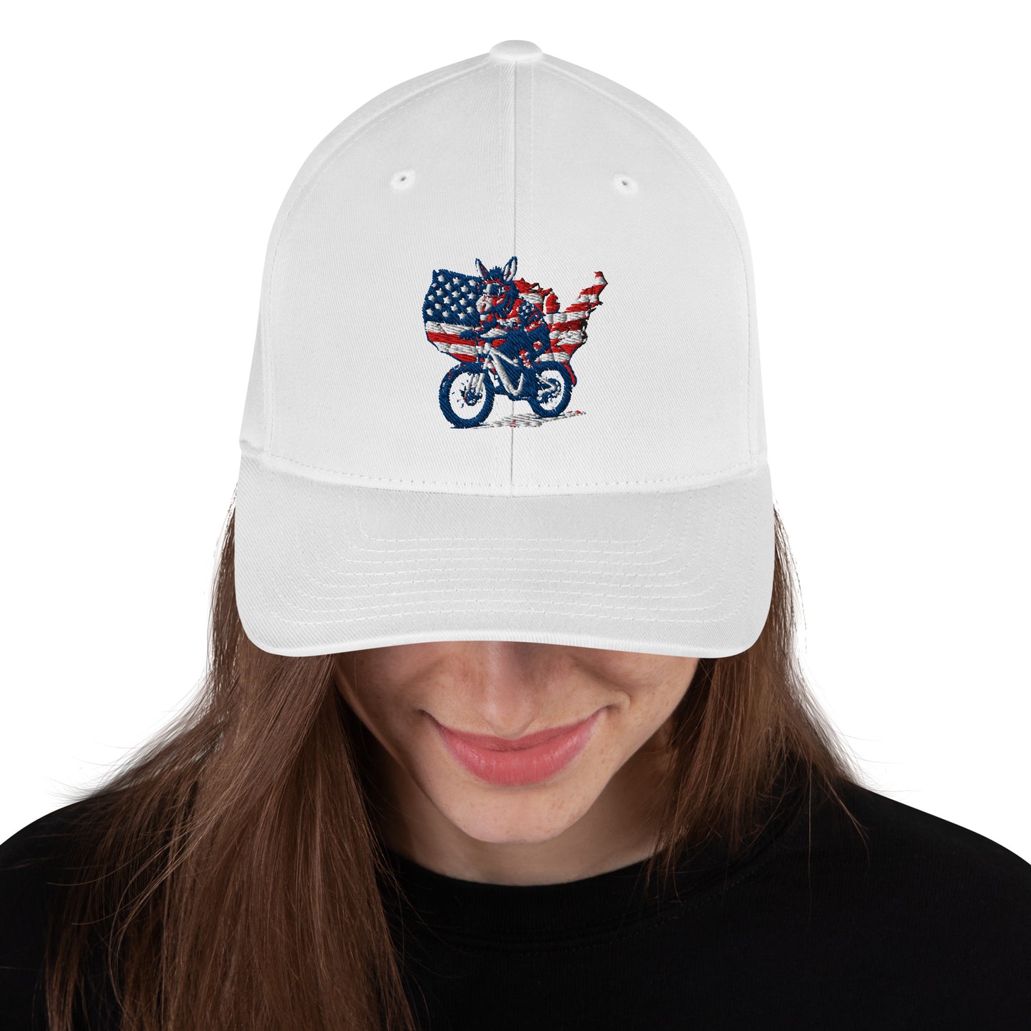 White cap with a graphic design of an eagle on a motorcycle and American flag, worn by a person.