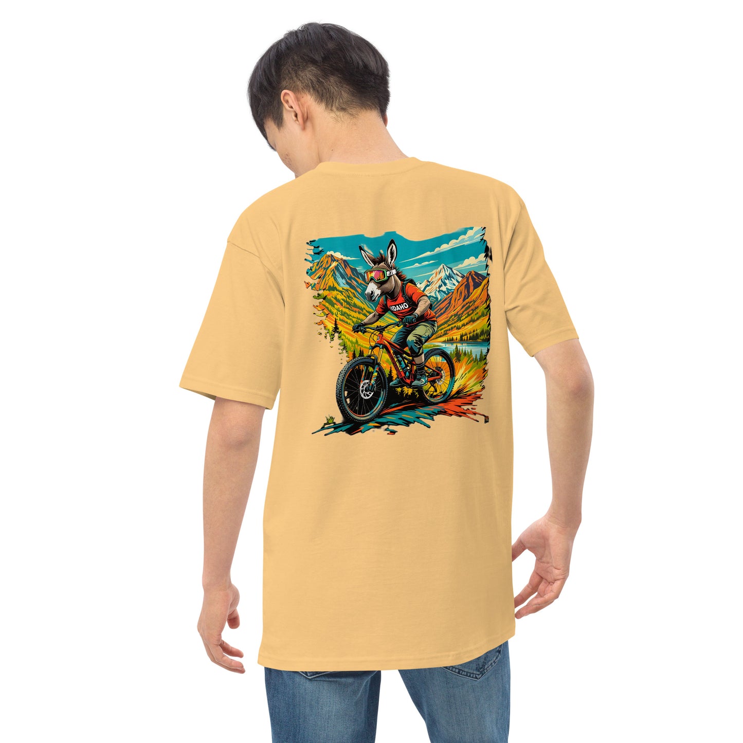 Person wearing a yellow t-shirt with a graphic design on the back, standing against a white background