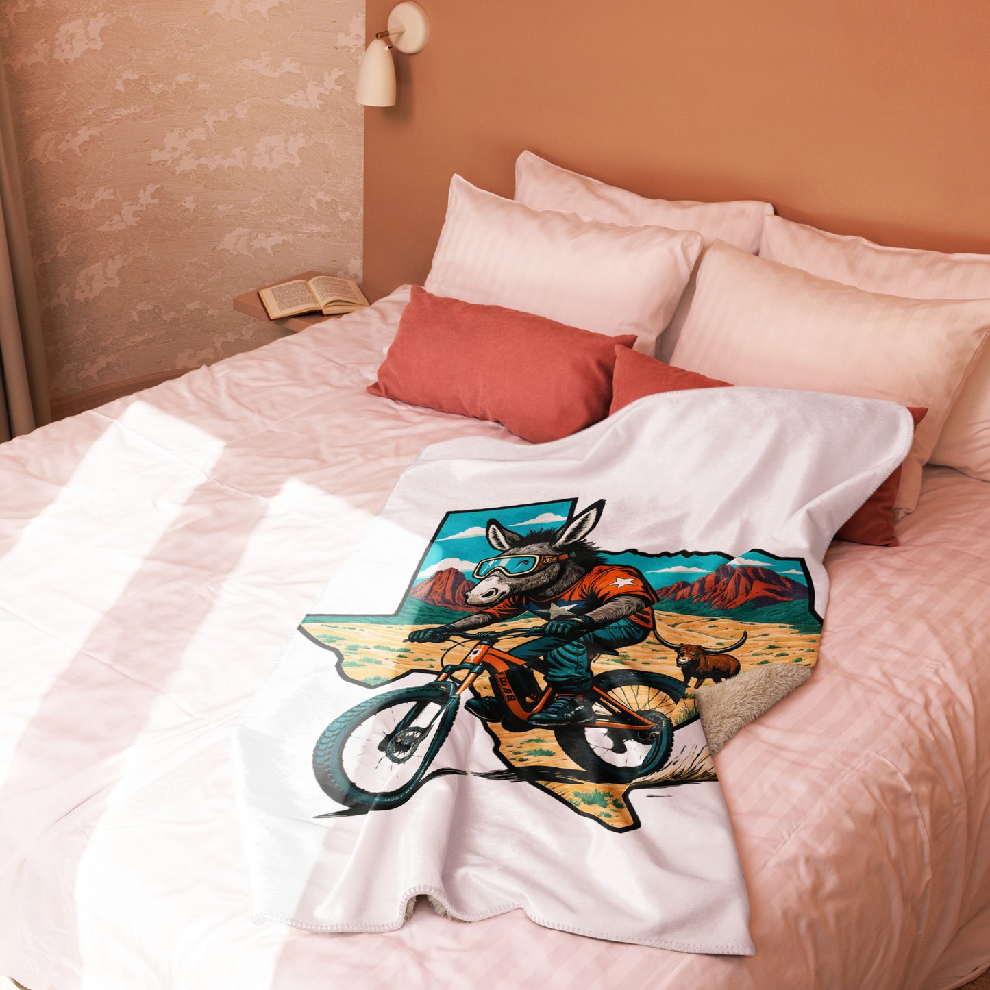Colorful blanket with a graphic design of a donkey on a motorcycle draped over a bed.