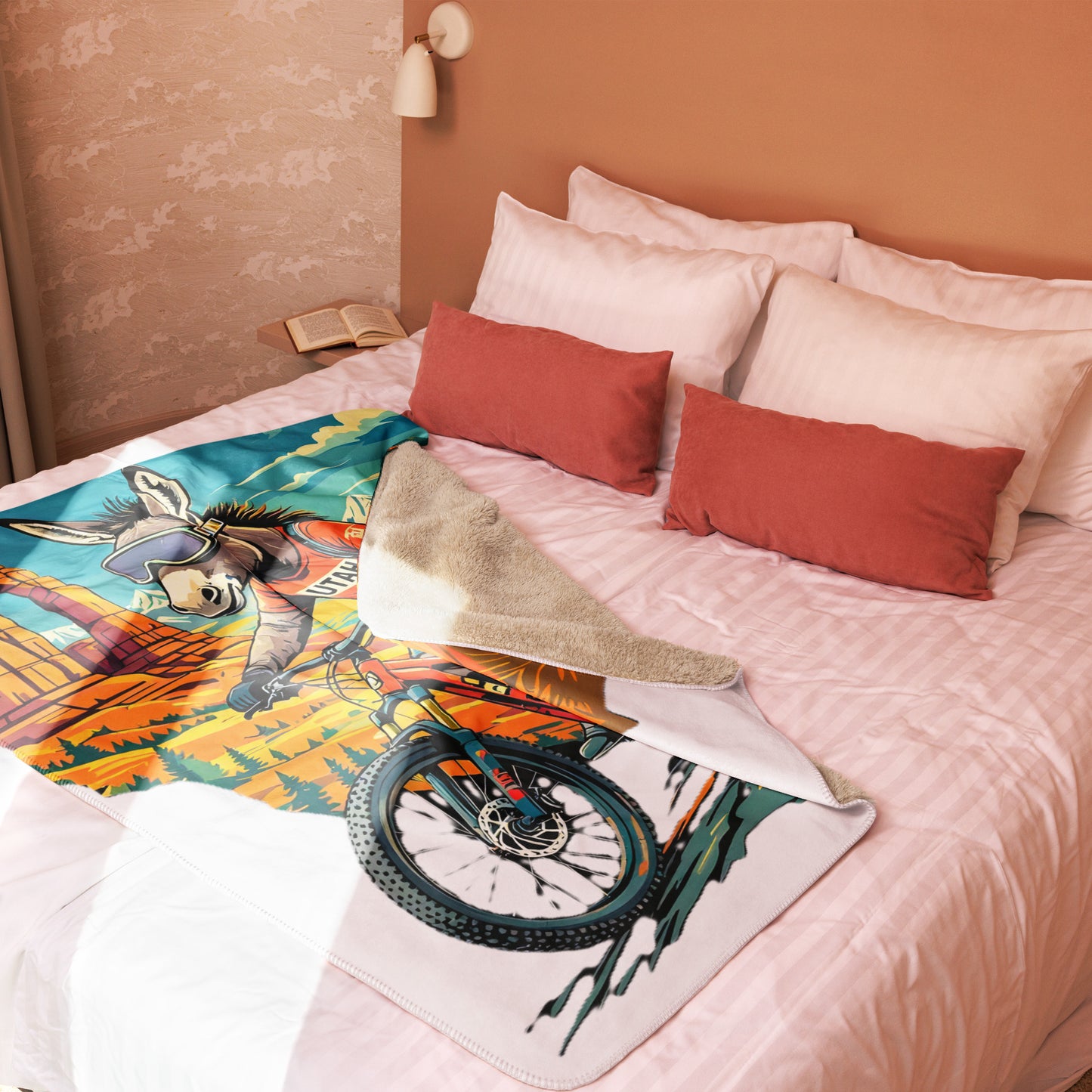 Colorful blanket with a donkey design on a bed with pillows.