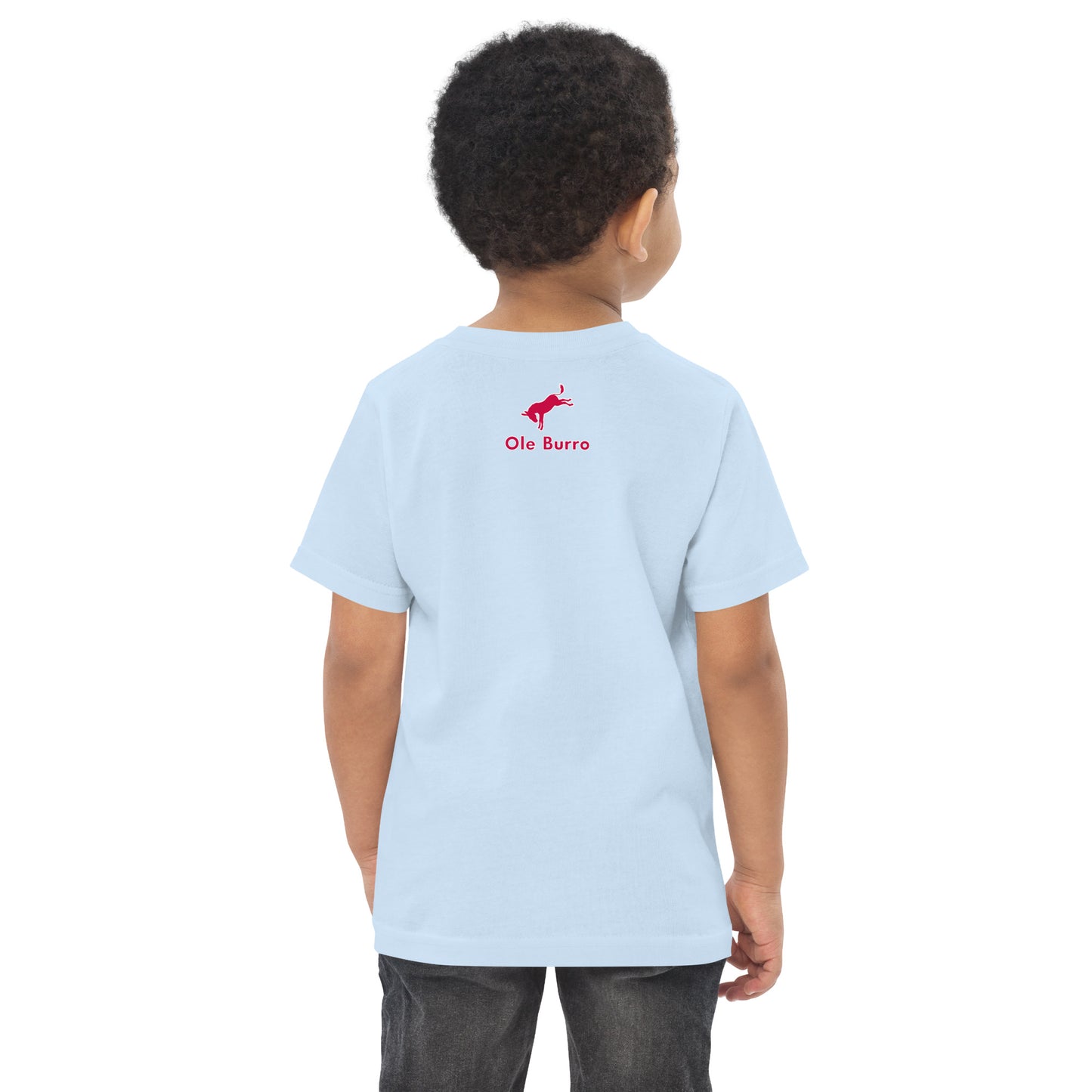 Child wearing a light blue t-shirt with a red logo on the back, standing against a white background.