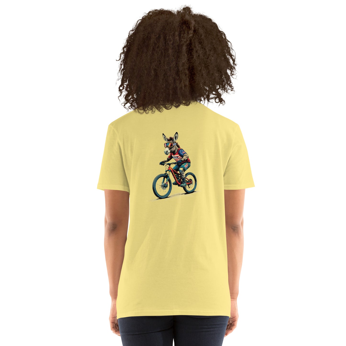 Person wearing a yellow t-shirt with a graphic of a dog riding a bike on the back.