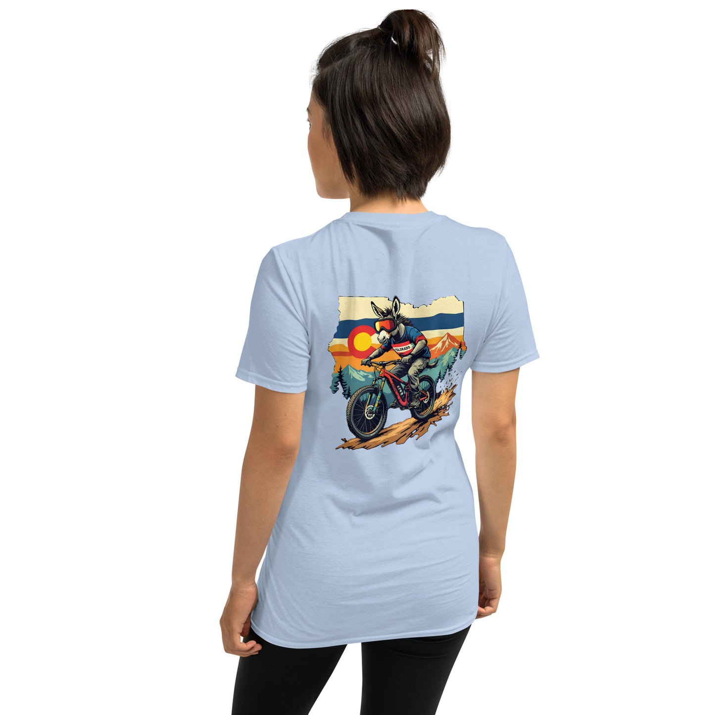 Person wearing a light blue t-shirt with a graphic of a motorcycle and sunset on the back.