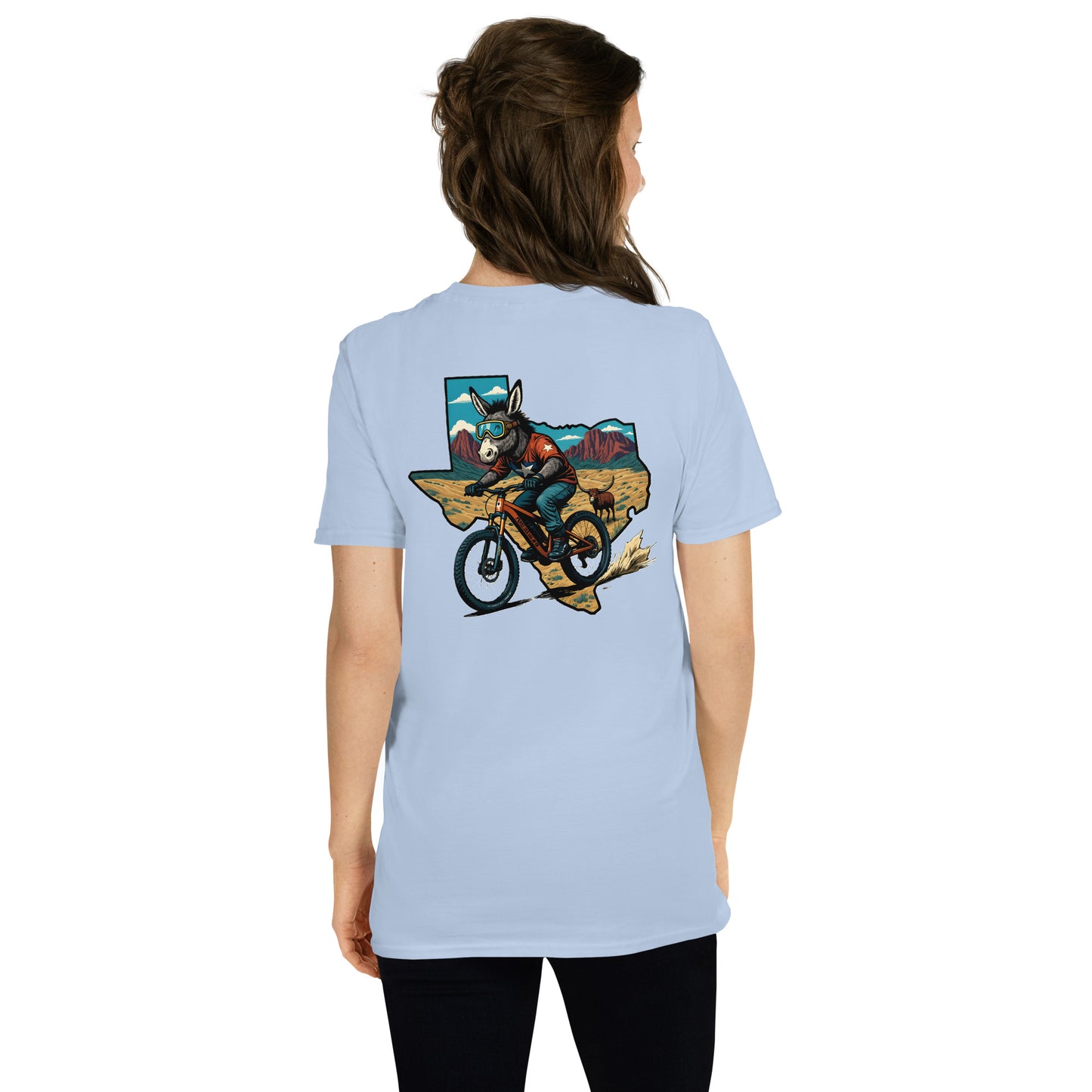 Light blue t-shirt with a graphic of a person on a bike and mountain scene on the back, worn by a person.