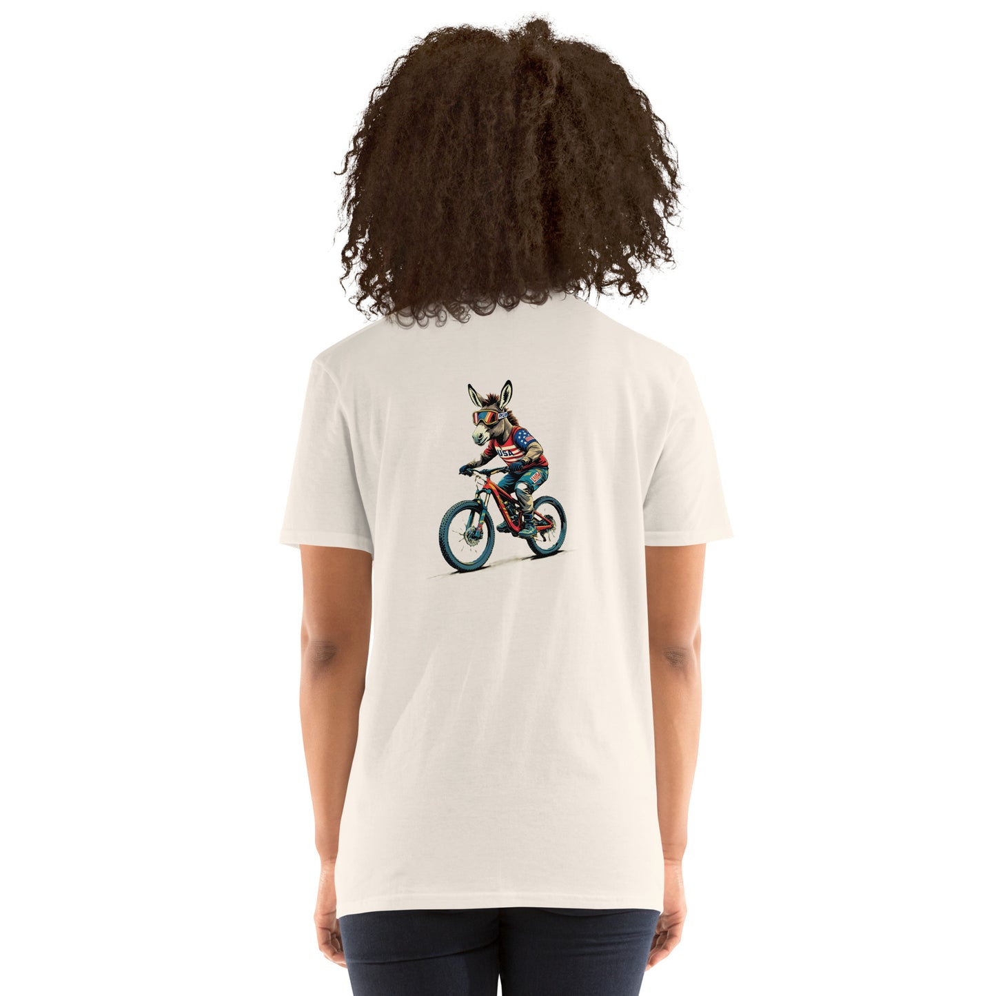 Person wearing a white t-shirt with a graphic of a person riding a bike on the back, on a white background.