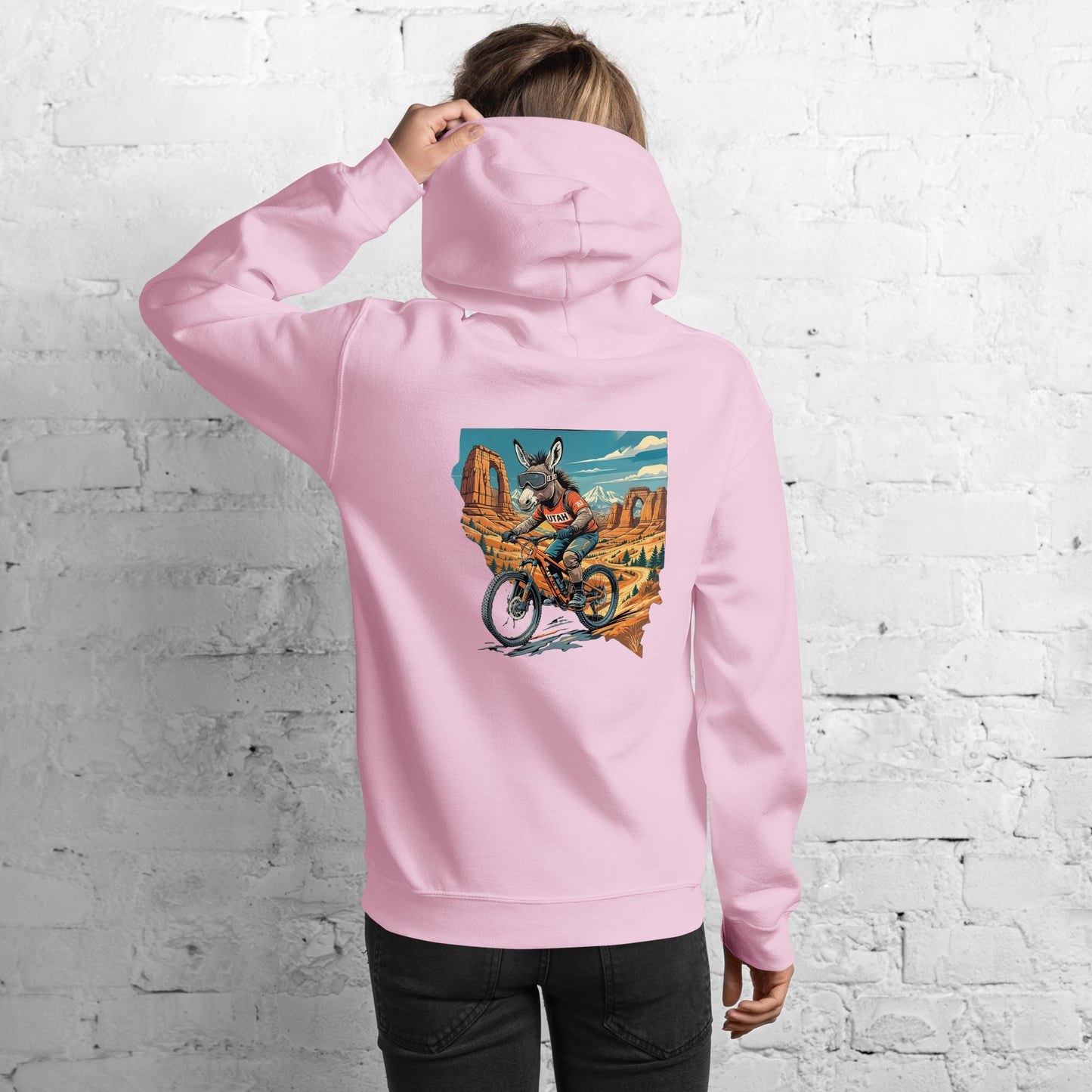 girl in pink hoodie with utah burro on back