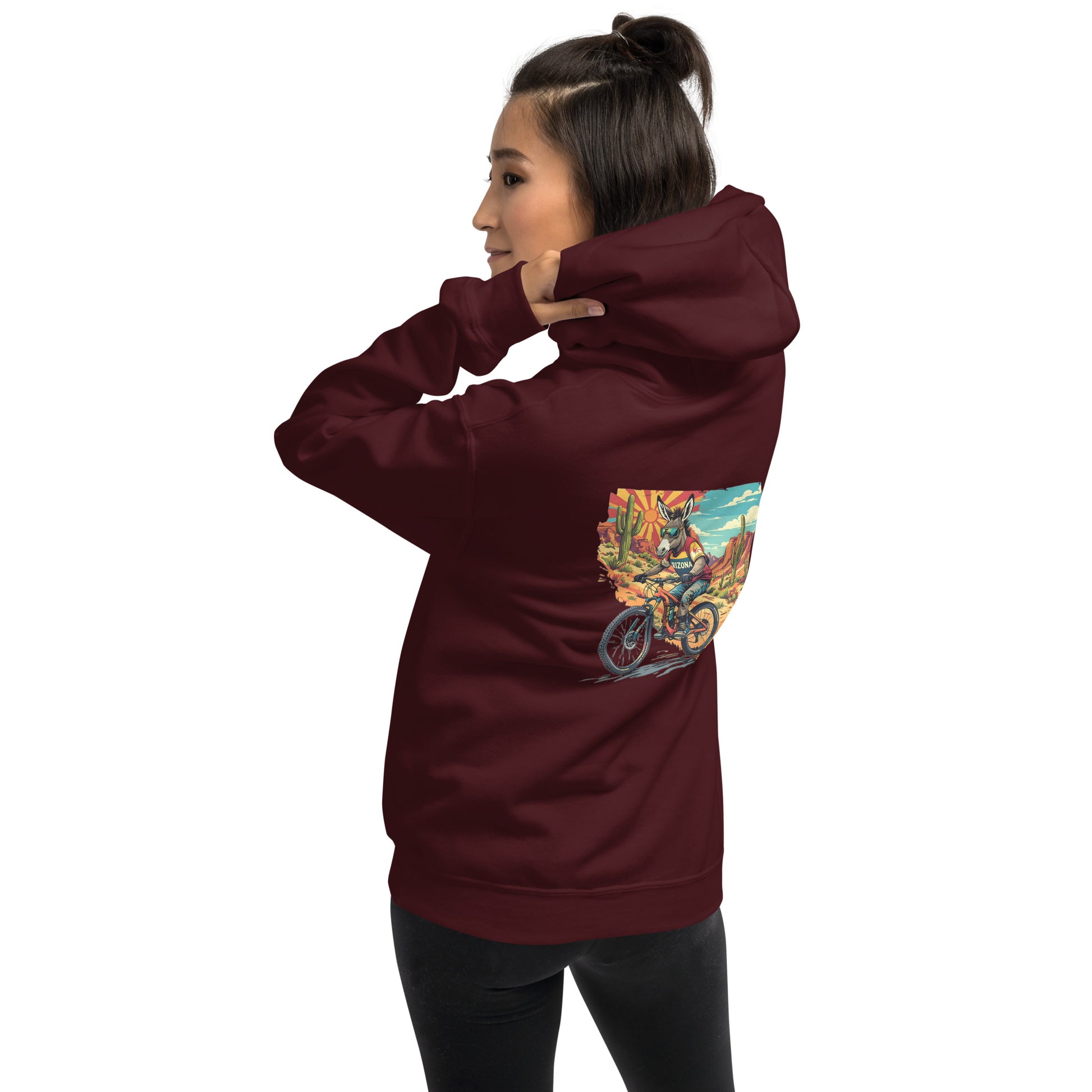 Person wearing a maroon hoodie with a colorful graphic on the back against a white background