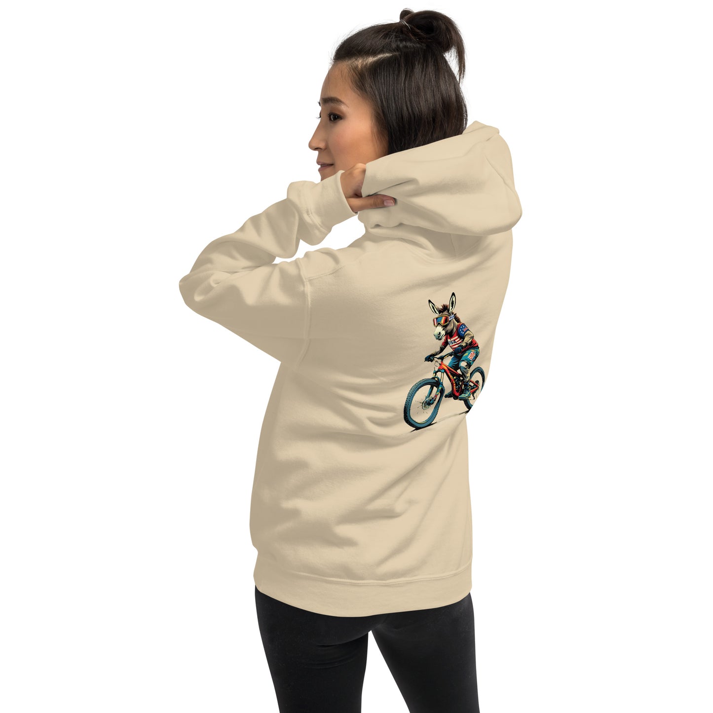 Person wearing a beige hoodie with a graphic design on the back against a white background