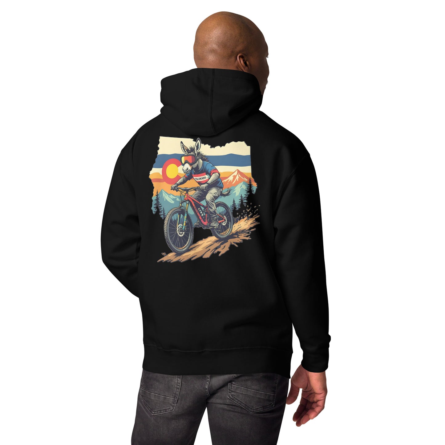 Person wearing a black hoodie with a graphic design on the back, standing against a white background