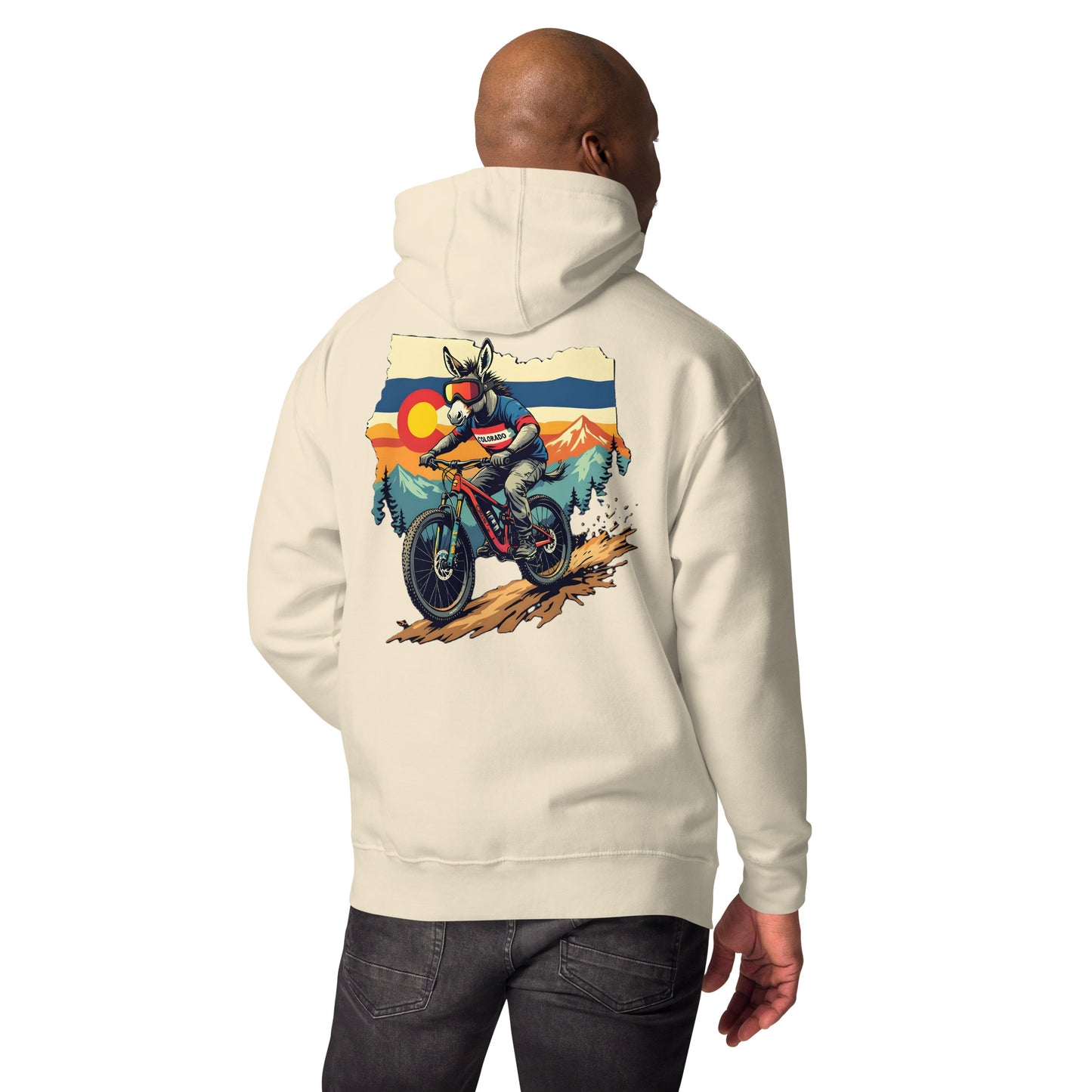 Person wearing a cream hoodie with a motorcycle graphic on the back against a white background