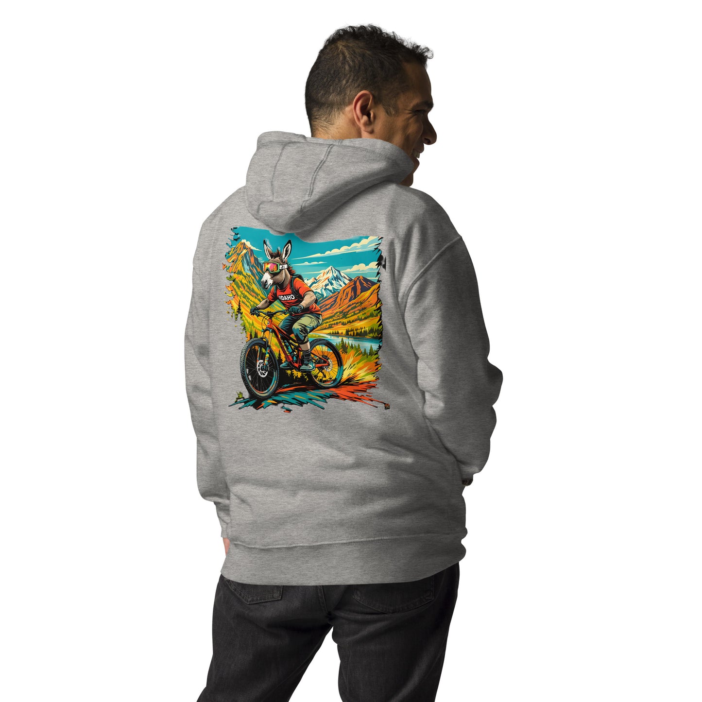 Person wearing a gray hoodie with a colorful graphic on the back, standing against a white background
