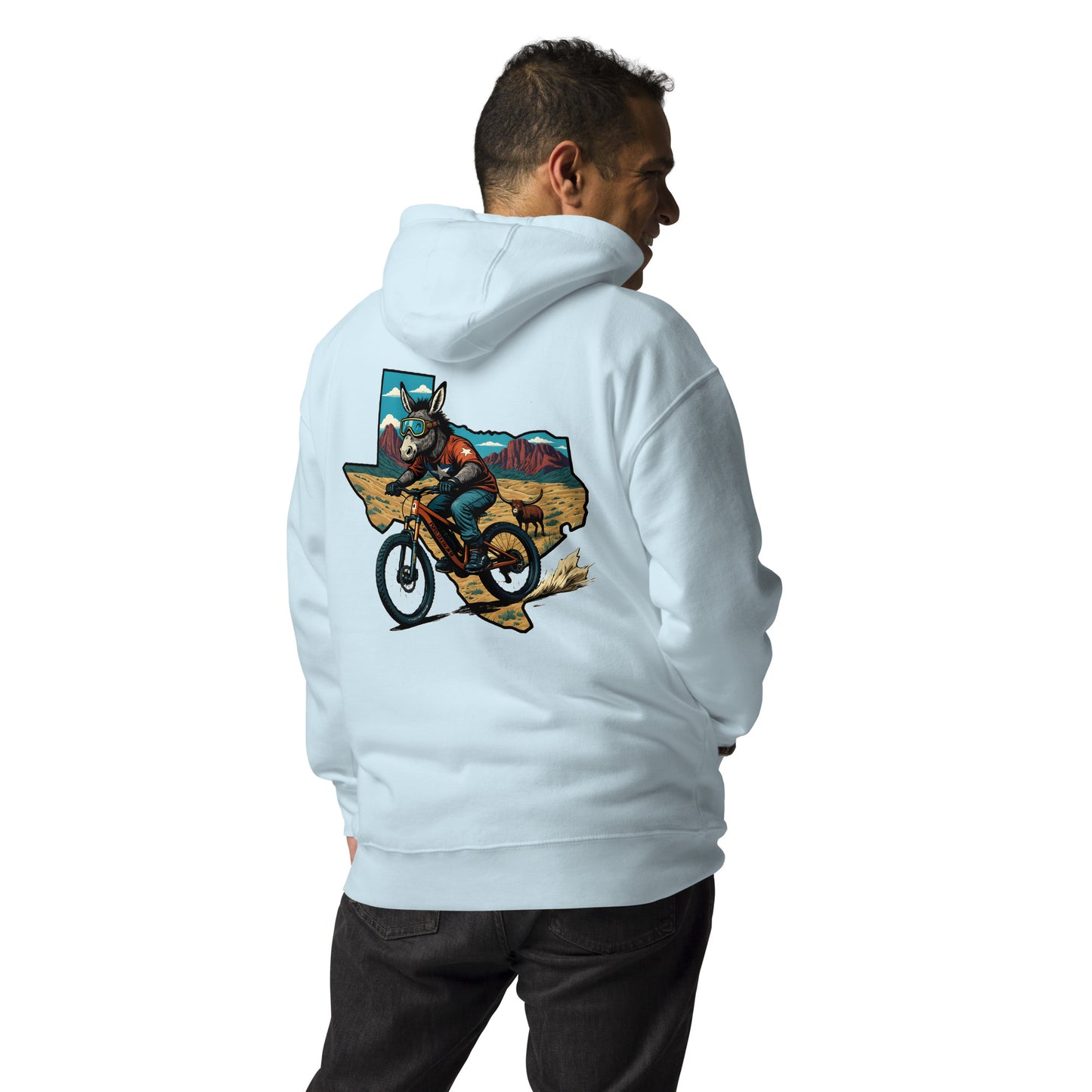 Person wearing a light blue hoodie with a graphic design on the back, standing against a white background.