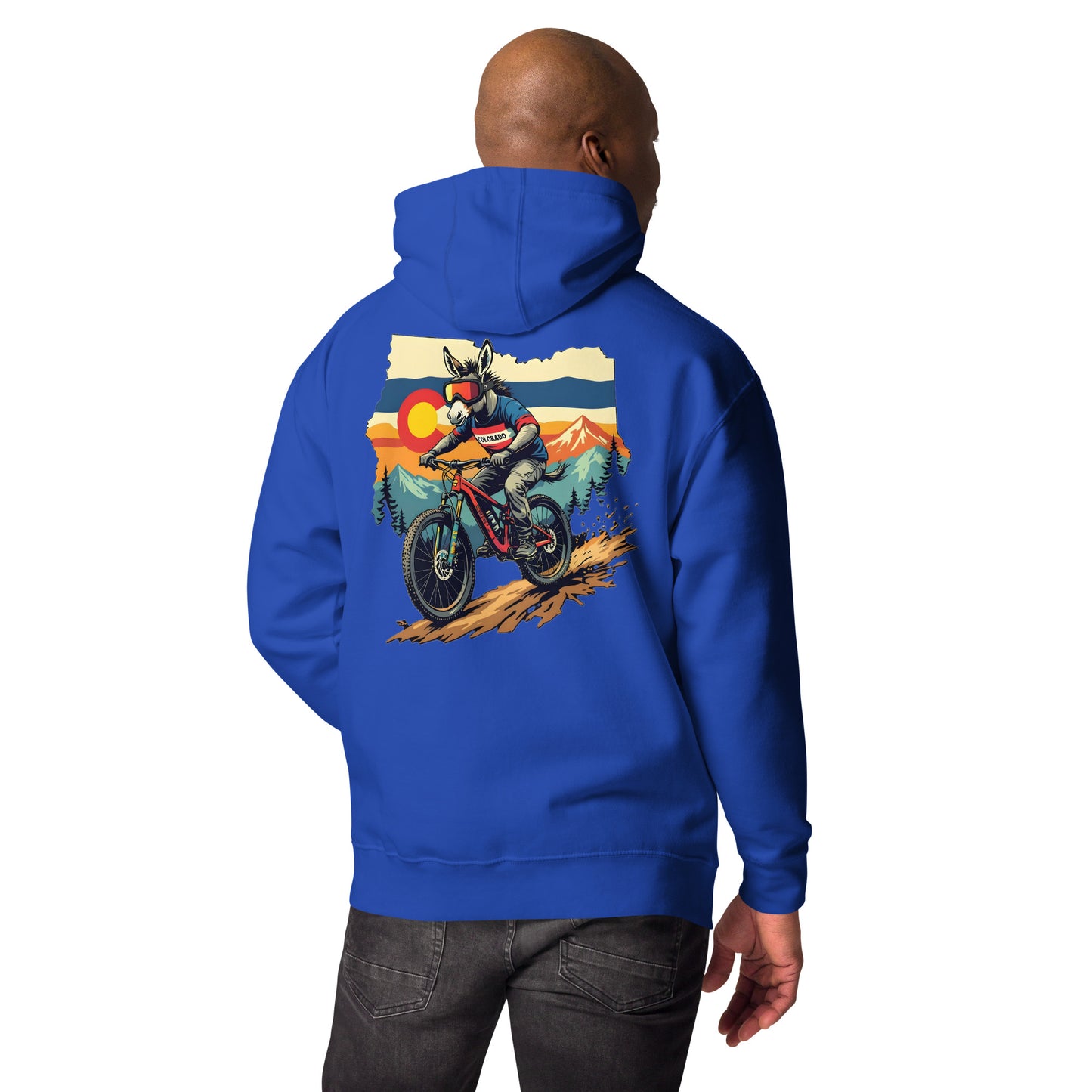 Person wearing a blue hoodie with a graphic of a person on a motorcycle and mountains on the back.