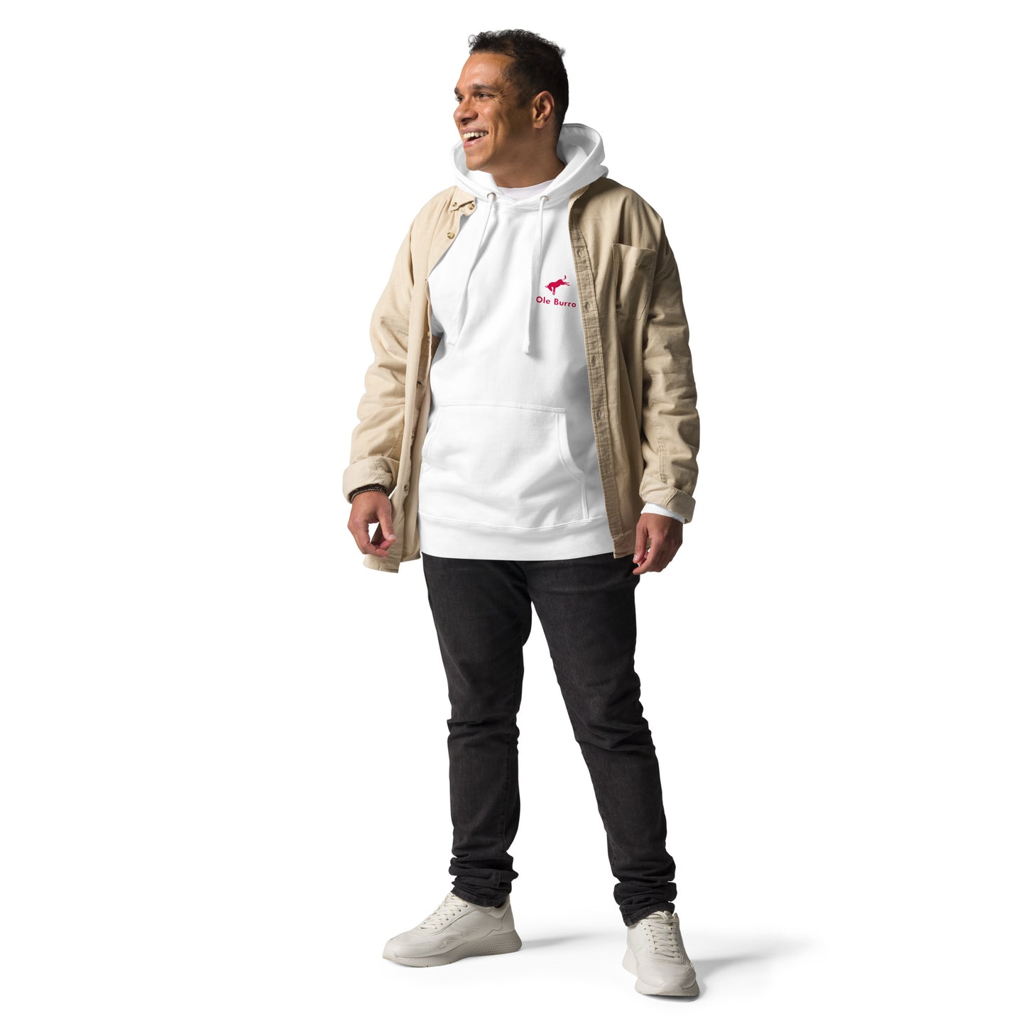 Man wearing a beige jacket over a white hoodie with a logo, black pants, and white sneakers on a white background