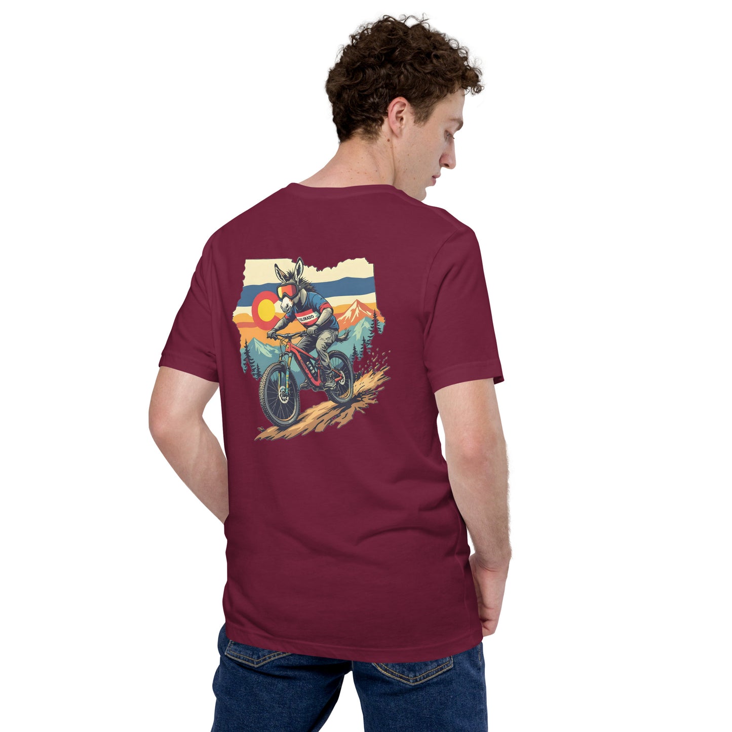 Person wearing a maroon t-shirt with a graphic of a motorcycle on the back, standing against a white background.