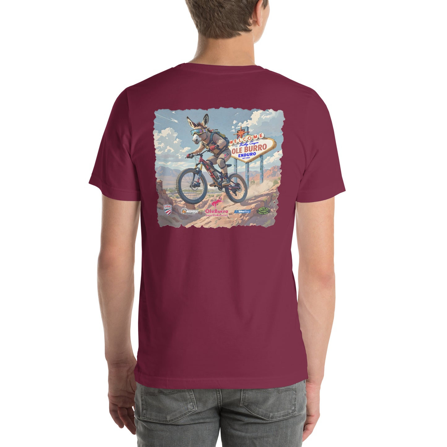 Maroon t-shirt with a graphic of a donkey on a bike and a sign in the desert.