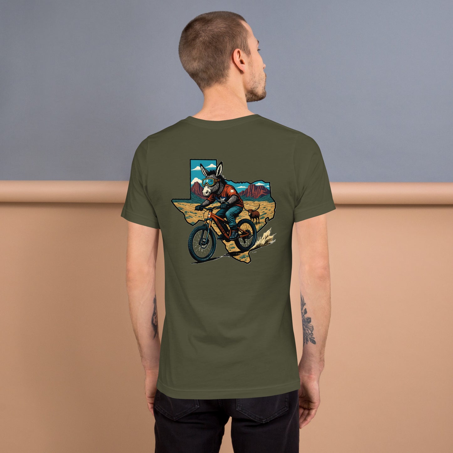 Person wearing a green t-shirt with a graphic design on the back, standing against a gradient background.