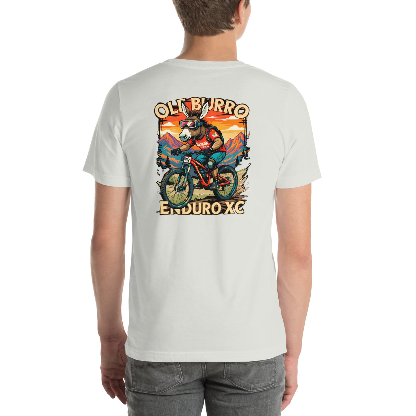 Person wearing a white t-shirt with a graphic design on the back, featuring a mountain bike rider and sunset landscape.