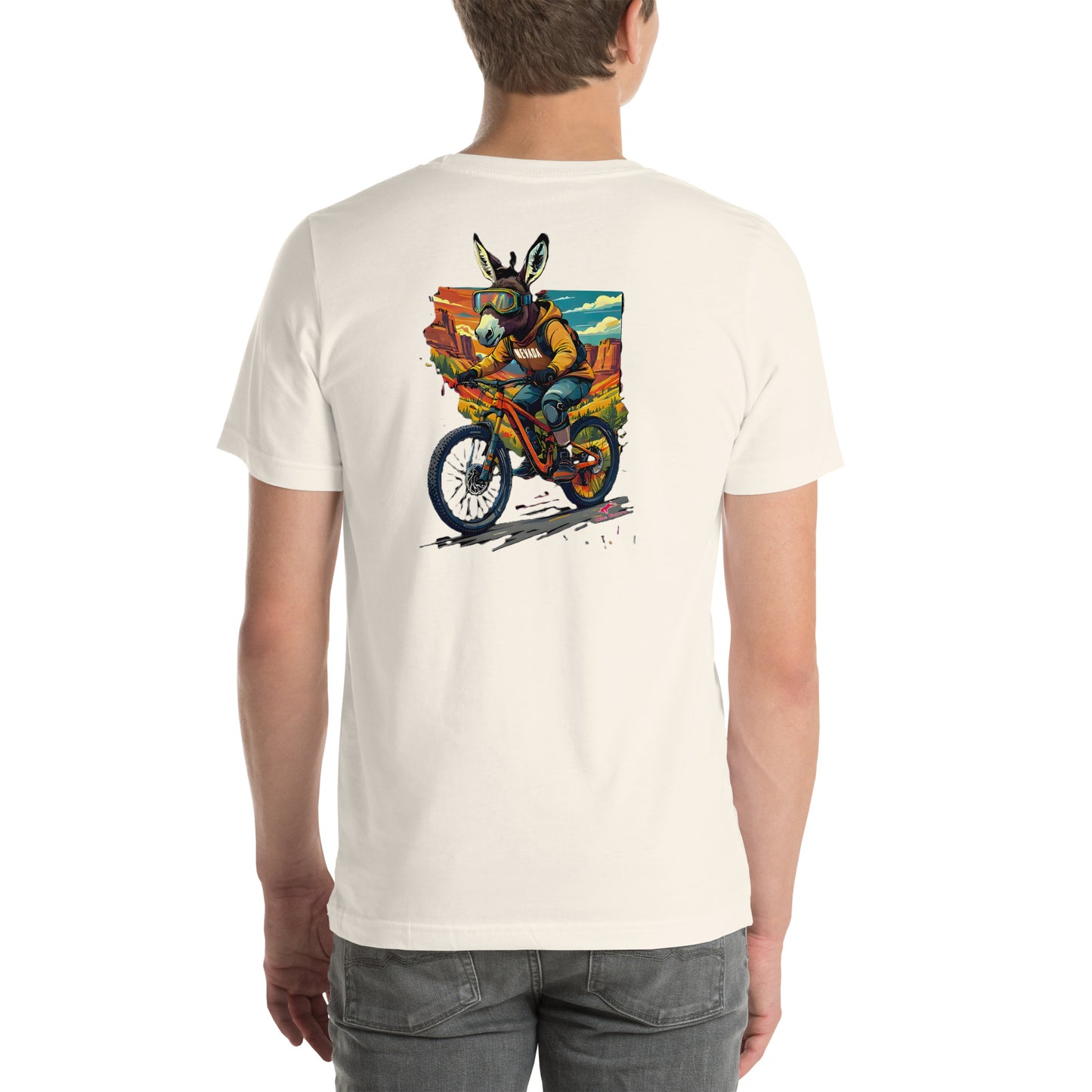 Person wearing a white t-shirt with a colorful graphic of a. burro on a mountain bike on the back.