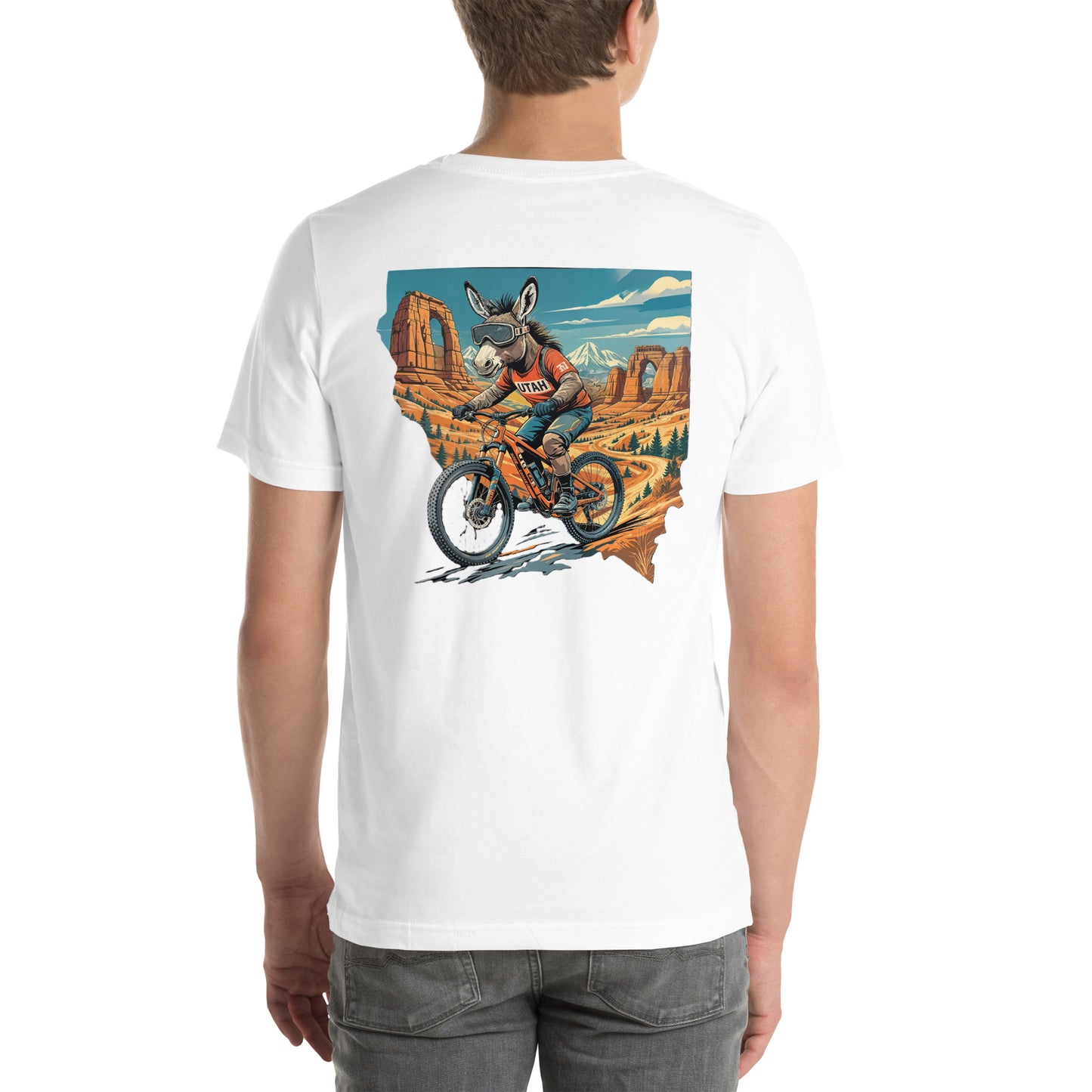 Person wearing a white t-shirt with a graphic of a donkey riding a bike in a desert landscape.