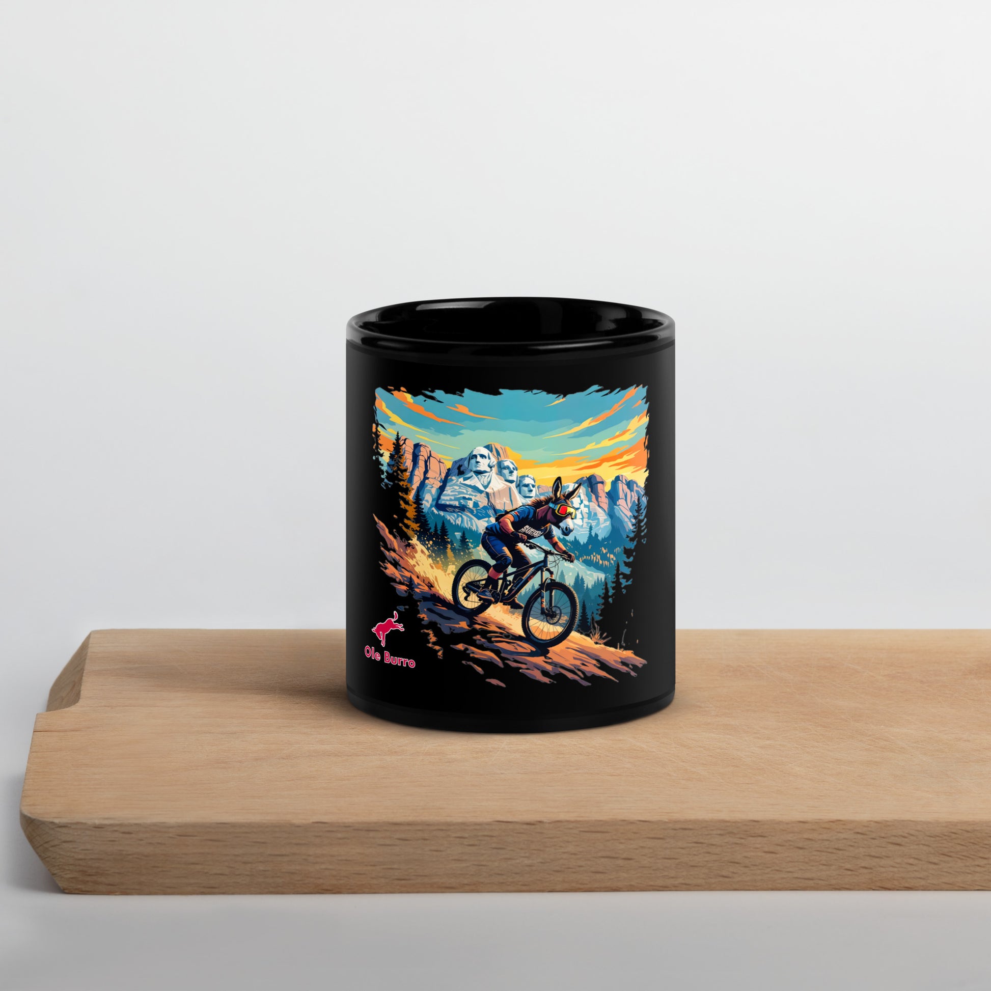 Black mug with mountain bike design on a wooden surface