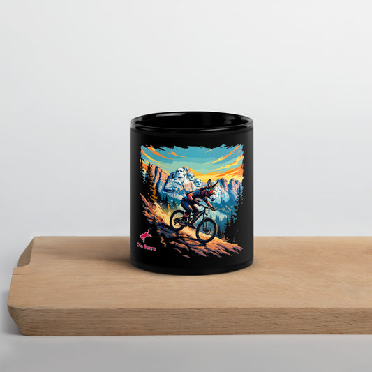 Black mug with mountain bike design on a wooden surface