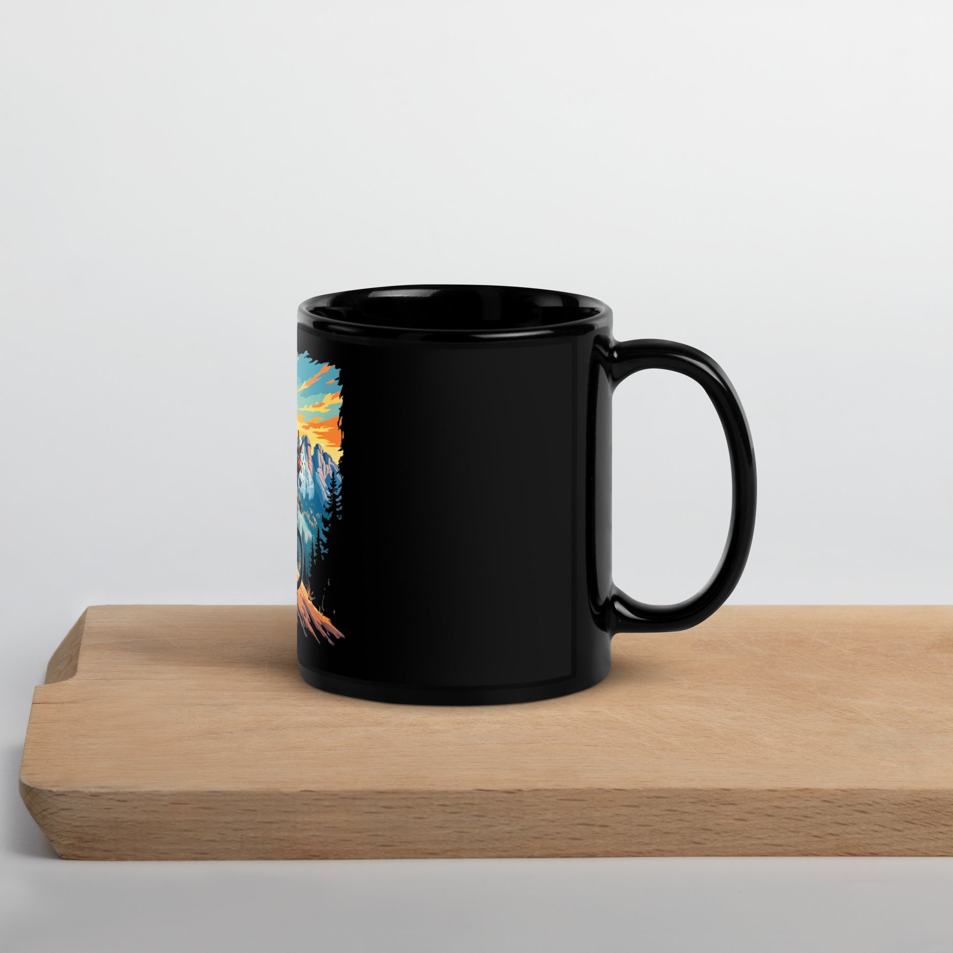 Black mug with a colorful design on a wooden surface