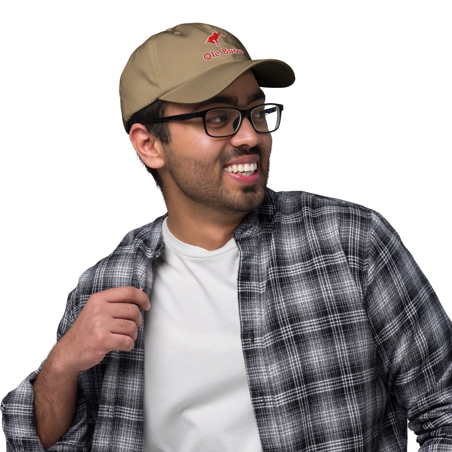 Man wearing a beige cap with a logo, plaid shirt, and glasses on a white background
