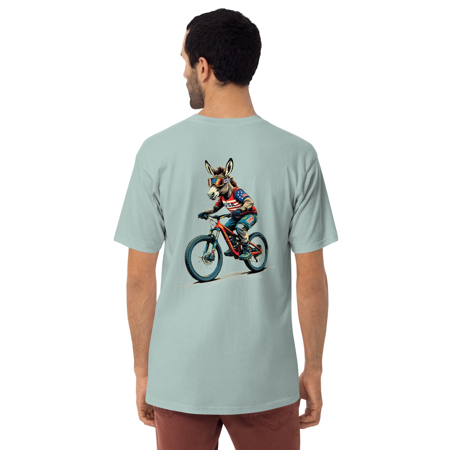 Person wearing a light blue t-shirt with a graphic of a donkey riding a bike on the back.