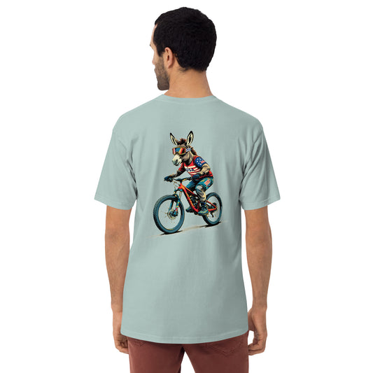 Person wearing a light blue t-shirt with a graphic of a donkey riding a bike on the back.