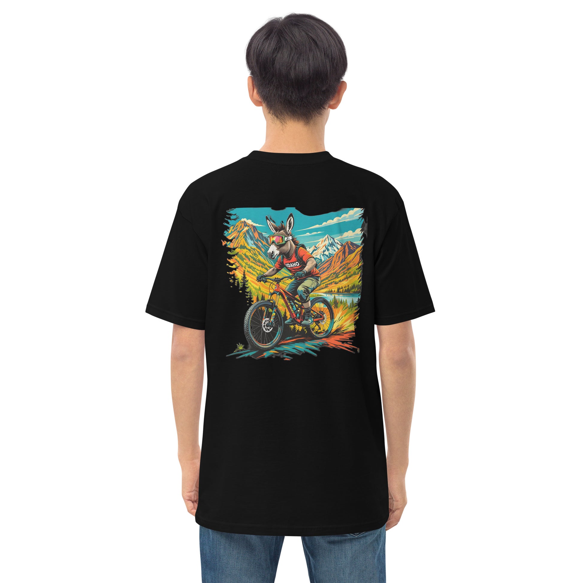 Person wearing a black t-shirt with a colorful graphic on the back, standing against a white background
