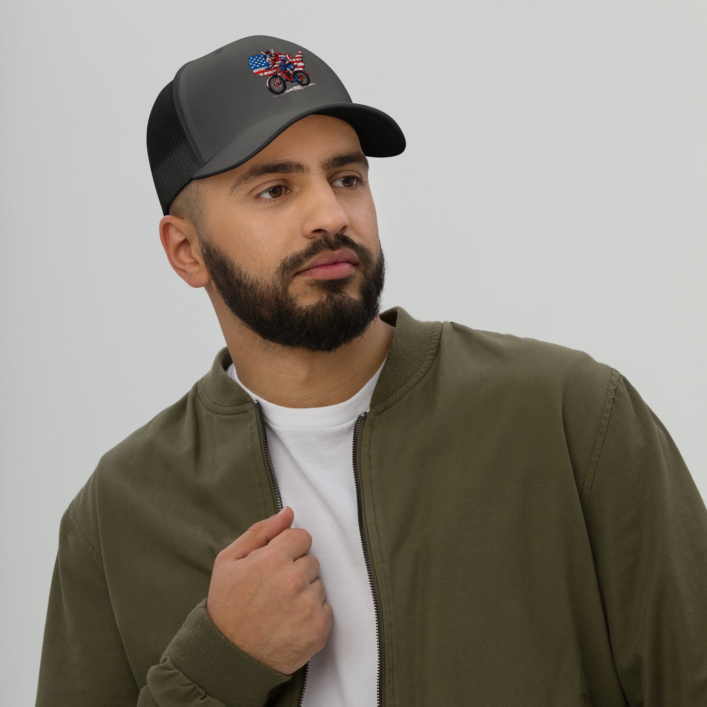 Man wearing a cap with a design on a plain background