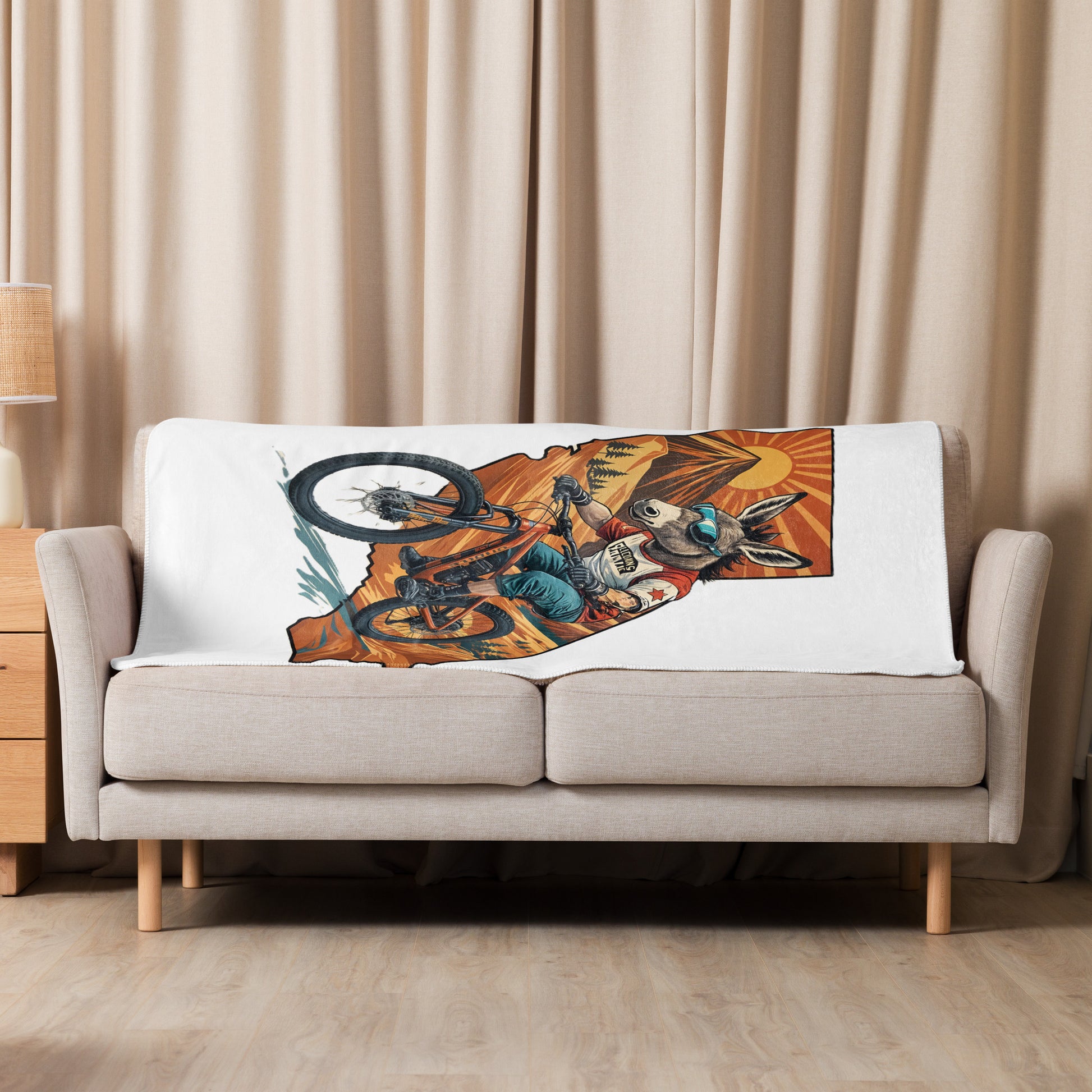 Sofa with a decorative pillow featuring a graphic design of a person on a bike.
