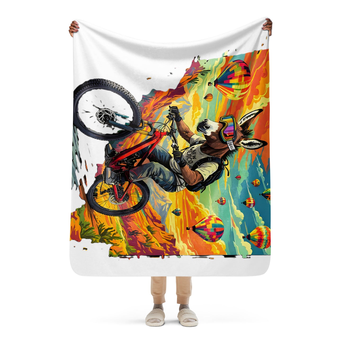 Person holding a colorful blanket with a graphic design of a person on a bike.