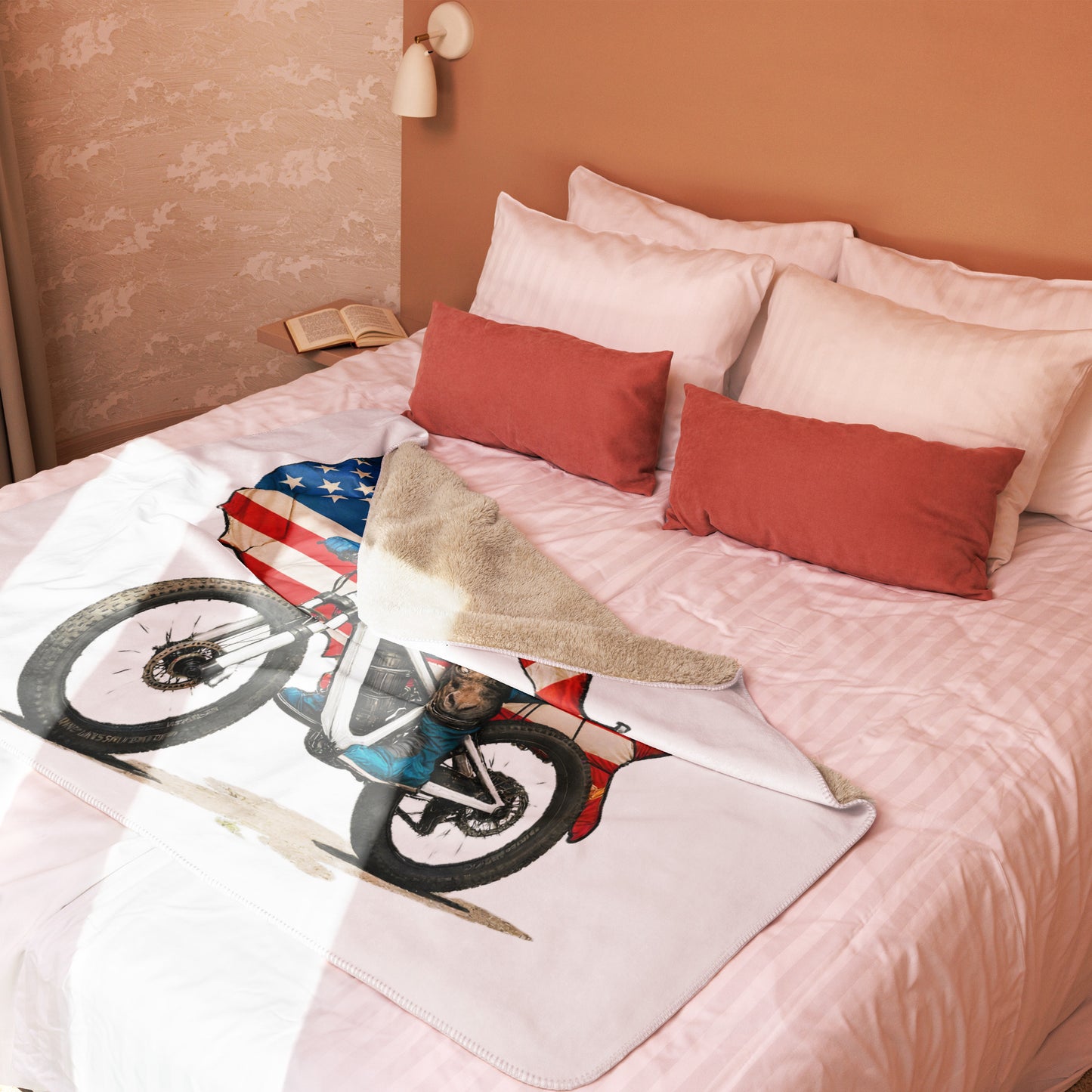 Bed with pillows and a blanket featuring a motorcycle design in a bedroom setting.