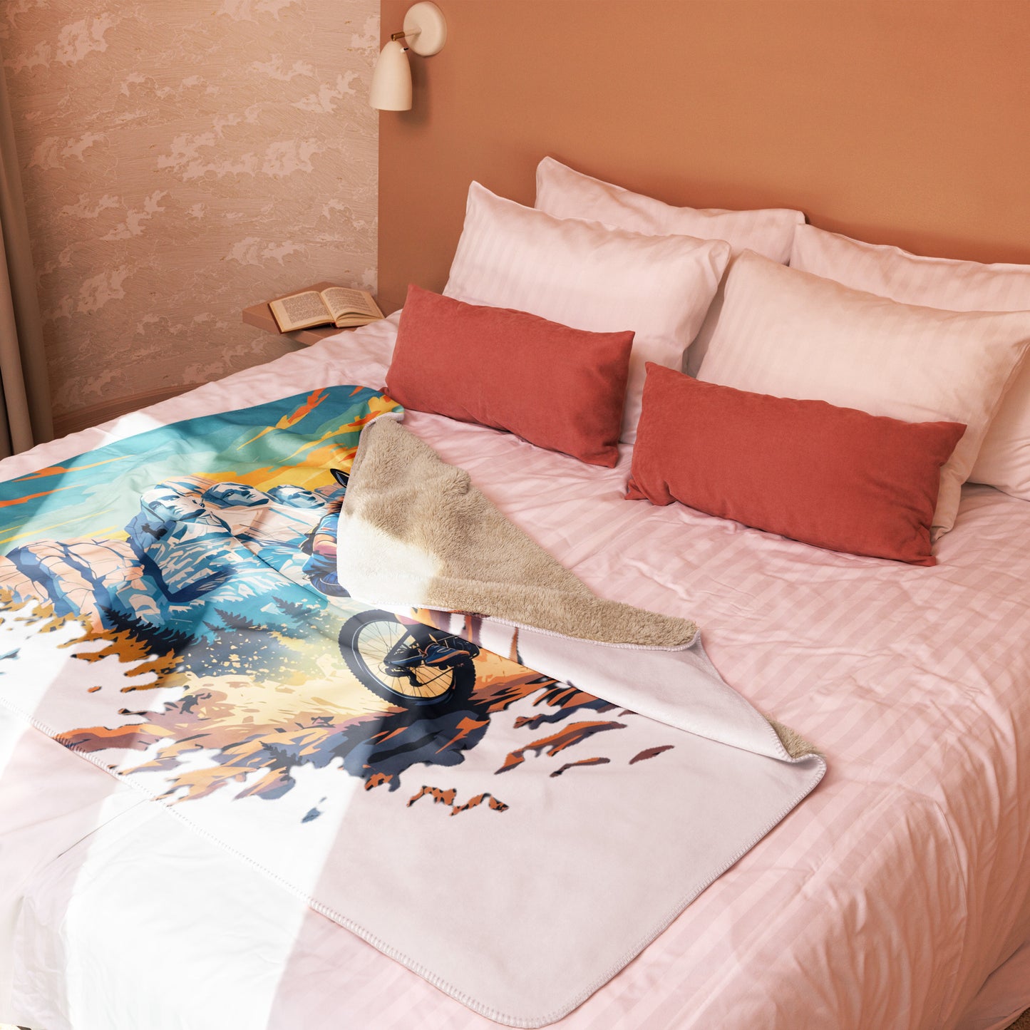 Bed with colorful mountain-themed blanket and red pillows