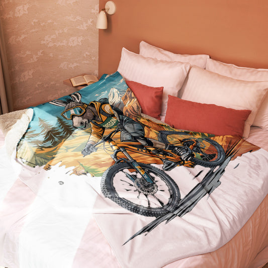 Bed with a colorful mountain bike design on a blanket, against a peach-colored wall.