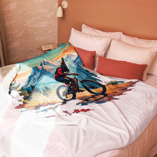 Bed with a colorful mountain bike design comforter and pillows.