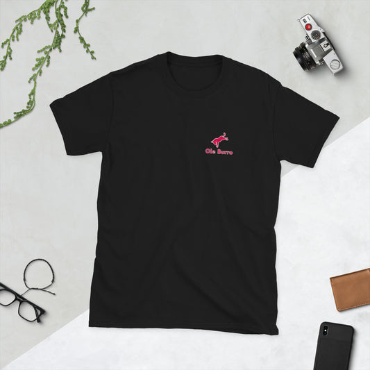 Black t-shirt with a red logo on a light gray surface with accessories around