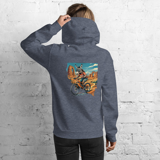 Person wearing a gray hoodie with a colorful graphic on the back against a white brick wall.