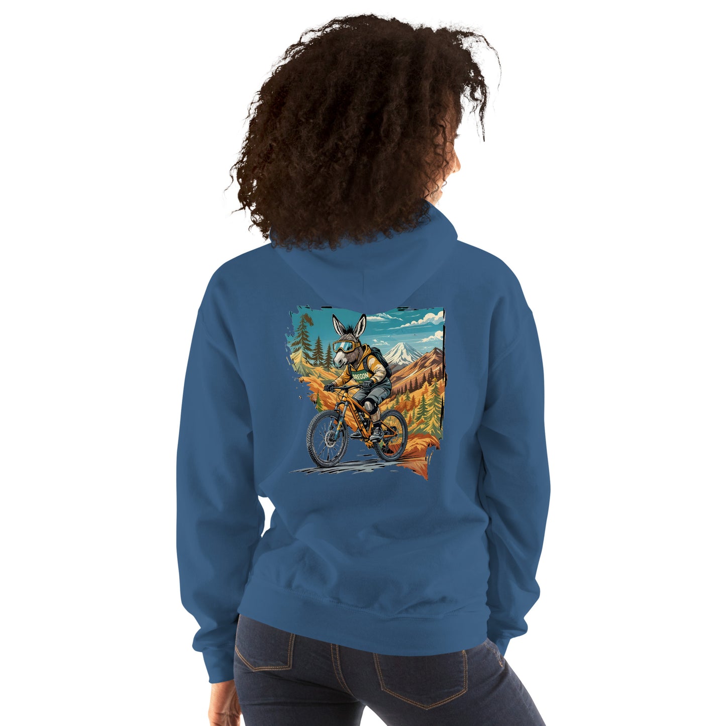 Person wearing a blue hoodie with a graphic of a person riding a bike in a mountainous landscape on the back.