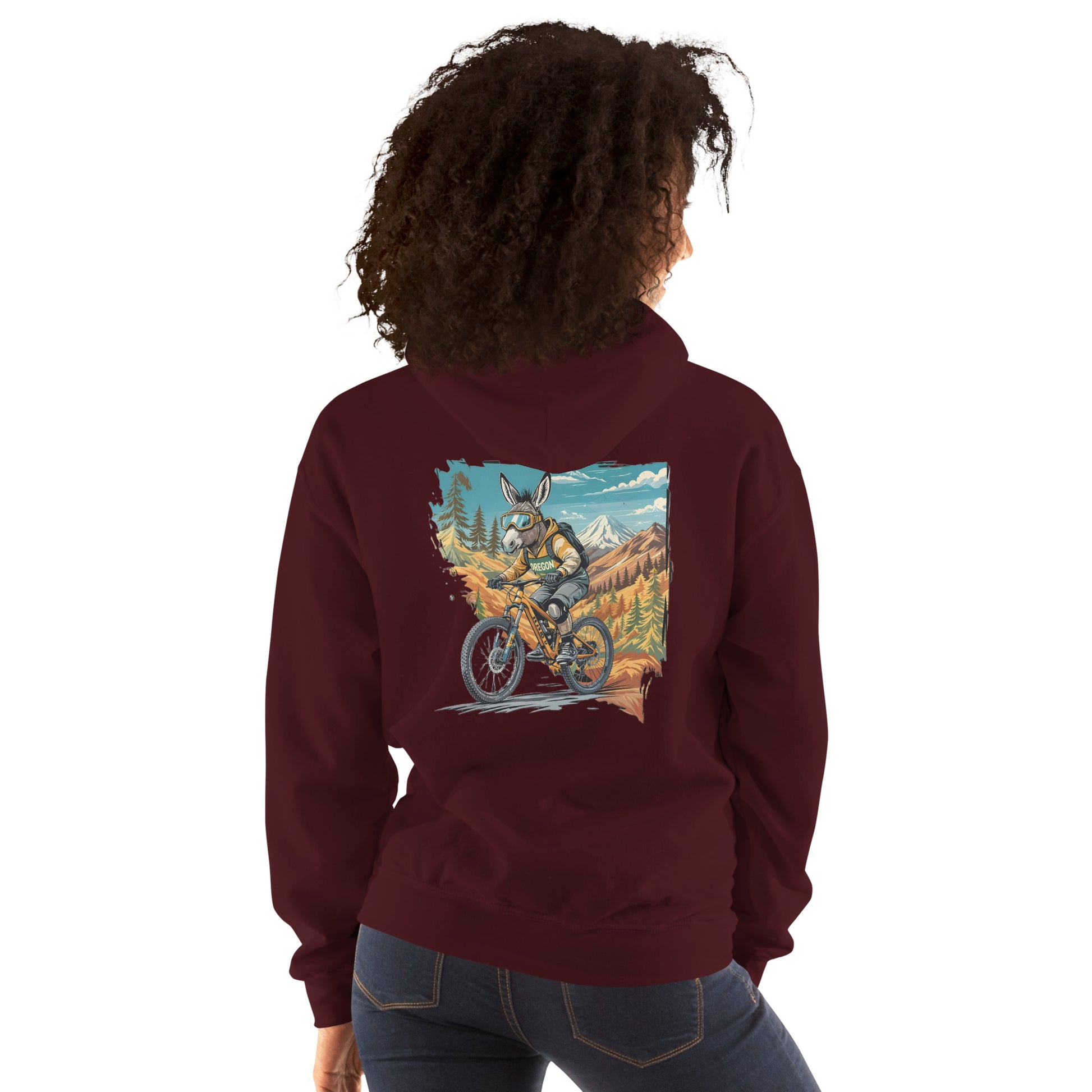 Person wearing a maroon hoodie with a graphic of a person on a bike in a mountainous landscape on the back.