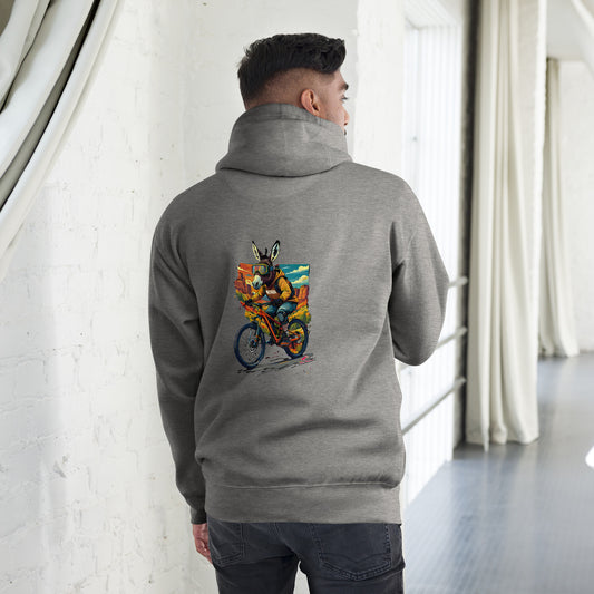 Person wearing a gray hoodie with a colorful graphic on the back, standing in a room with white walls and a window.