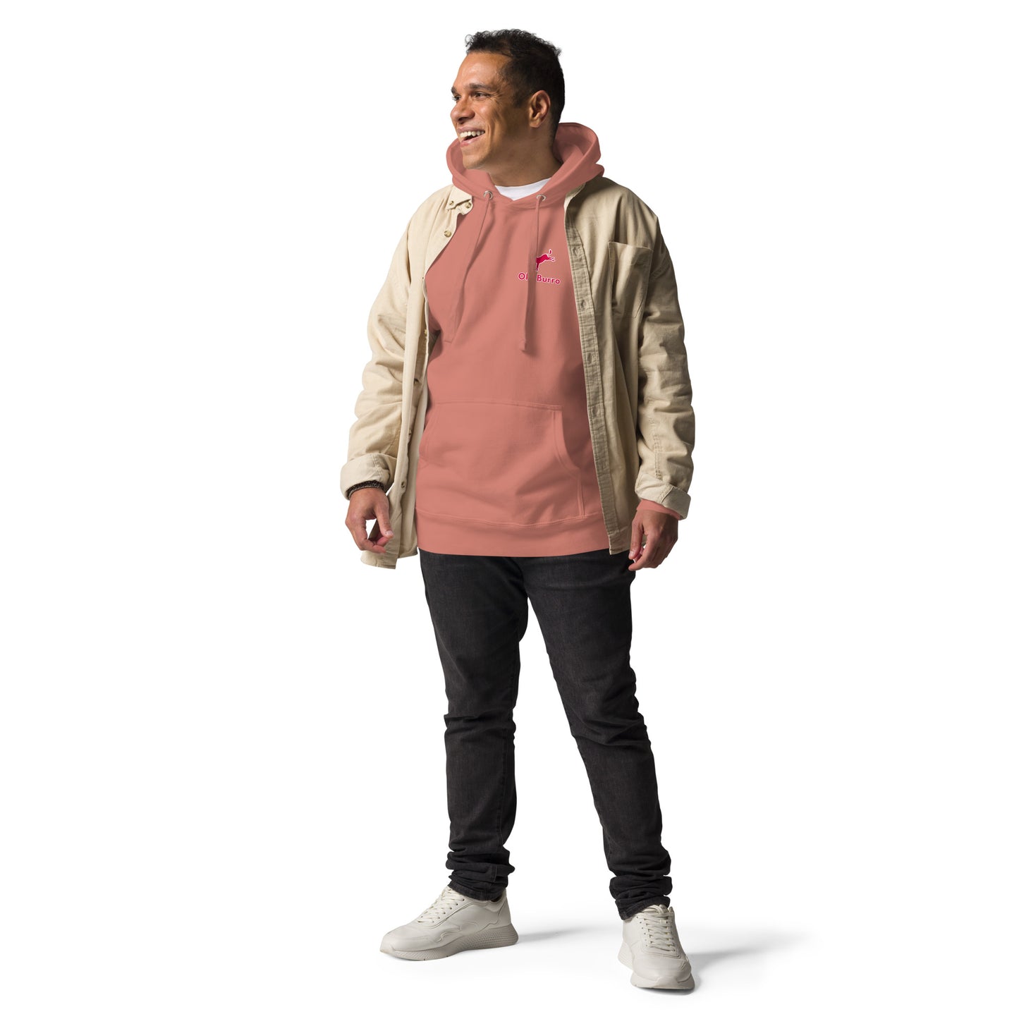 Man wearing a beige jacket over a pink hoodie with black pants on a white background